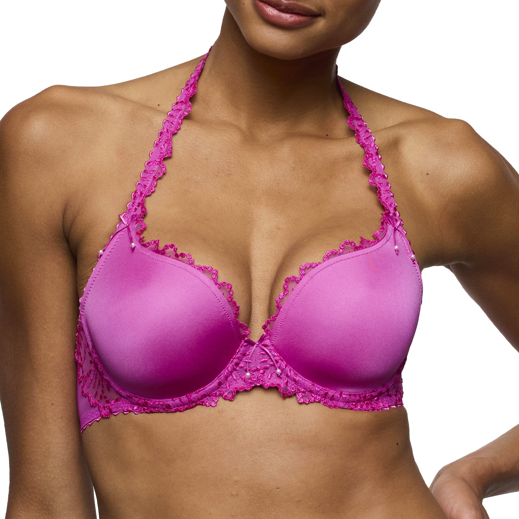 Close-up angled view of fuchsia lace underwire bra showing lace straps and smooth cup shaping.
