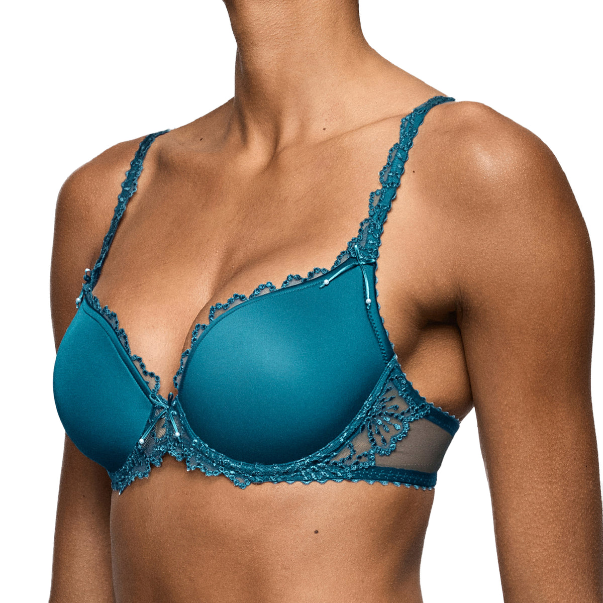 Side view of a peacock teal padded bra with smooth cups, embroidered lace side panels and lace-detailed straps.