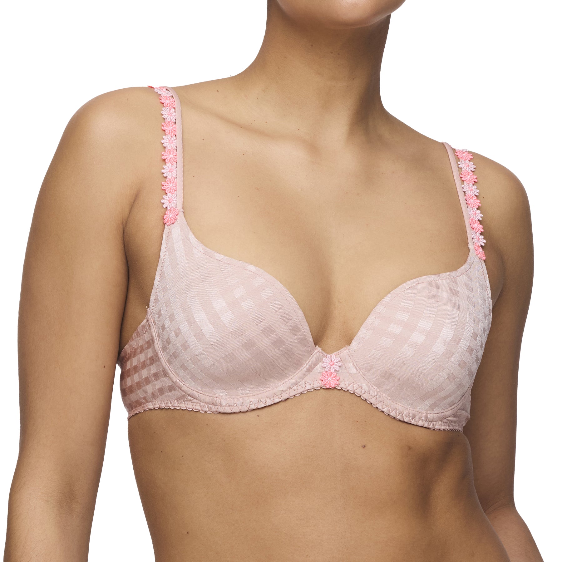 Close-up of pastel pink padded cup bra worn by model, showcasing floral detail on straps.