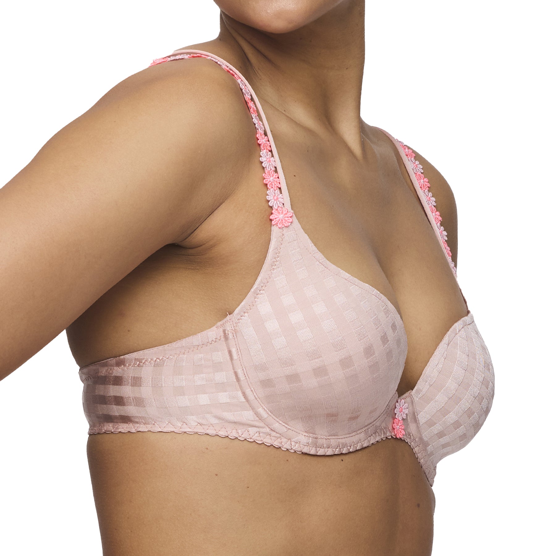 Side view of bra in pink fabric with pink floral embroidery on straps, worn by model.