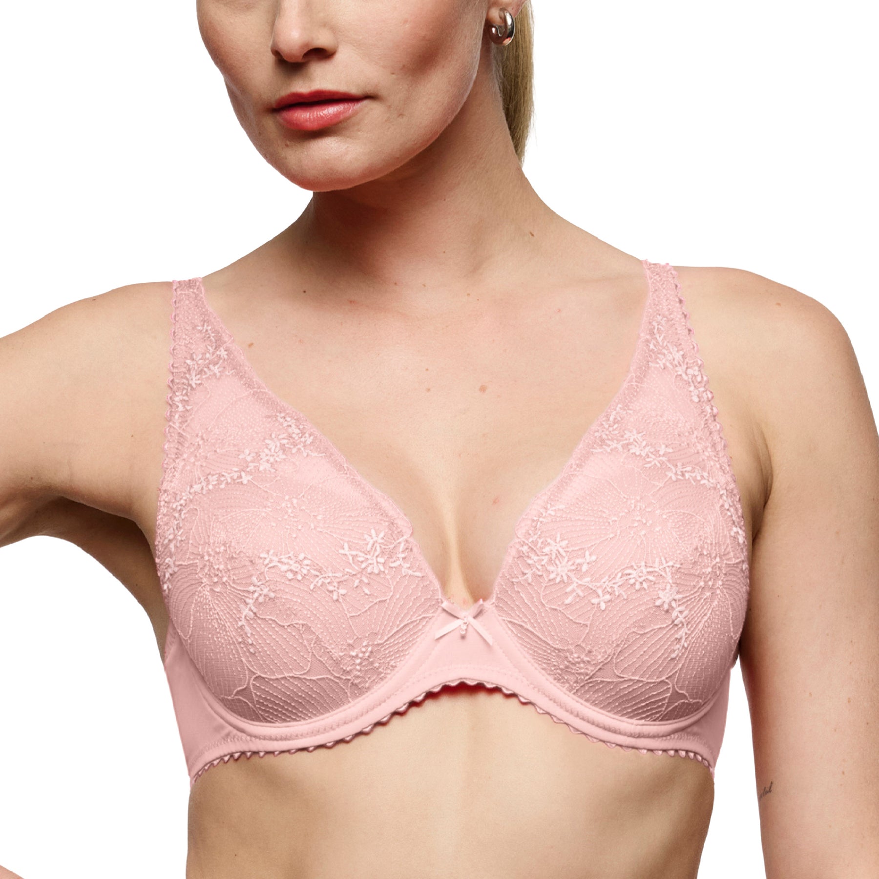 Close-up front view of a blush pink plunge bra with sheer floral embroidery, underwire cups, and a flattering V-neck plunge.