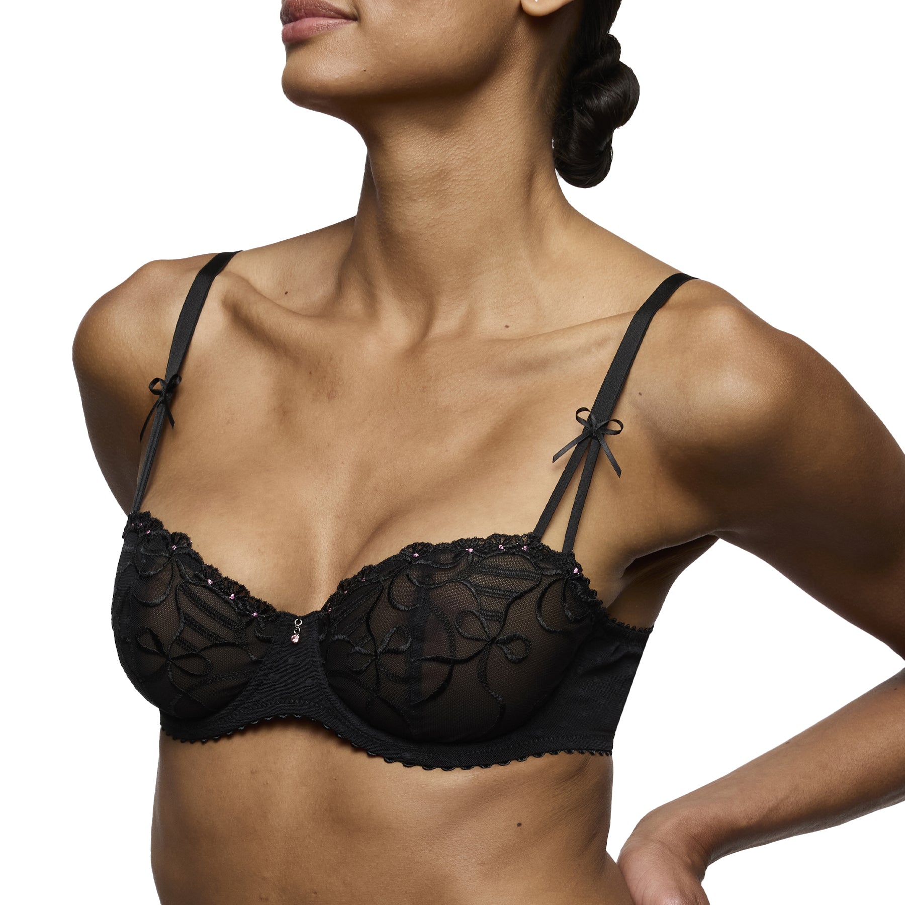 Side view of model wearing Marie Jo Noova black underwired bra with sheer embroidered cups and bow straps.