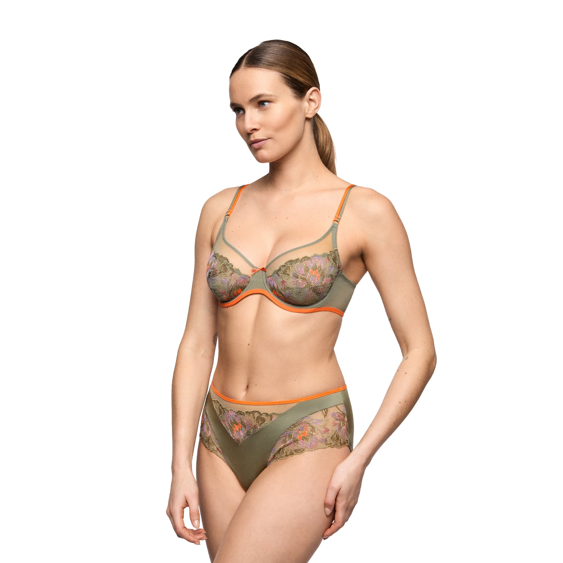 Model wearing an olive green floral embroidered bra and matching high-waist brief with sheer panels and contrasting peach trim.
