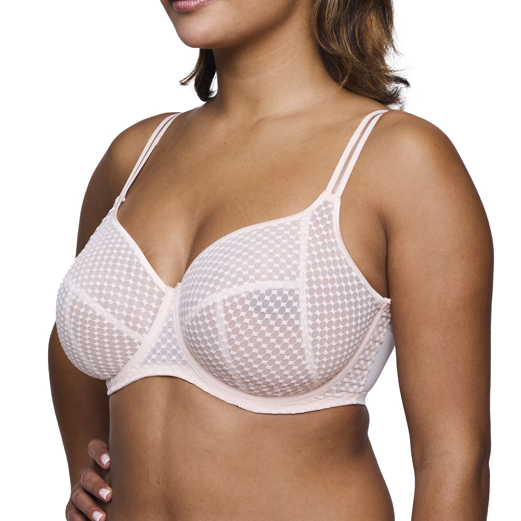 Side view of a woman in a supportive beige bra with a subtle check pattern and wide underwire band.