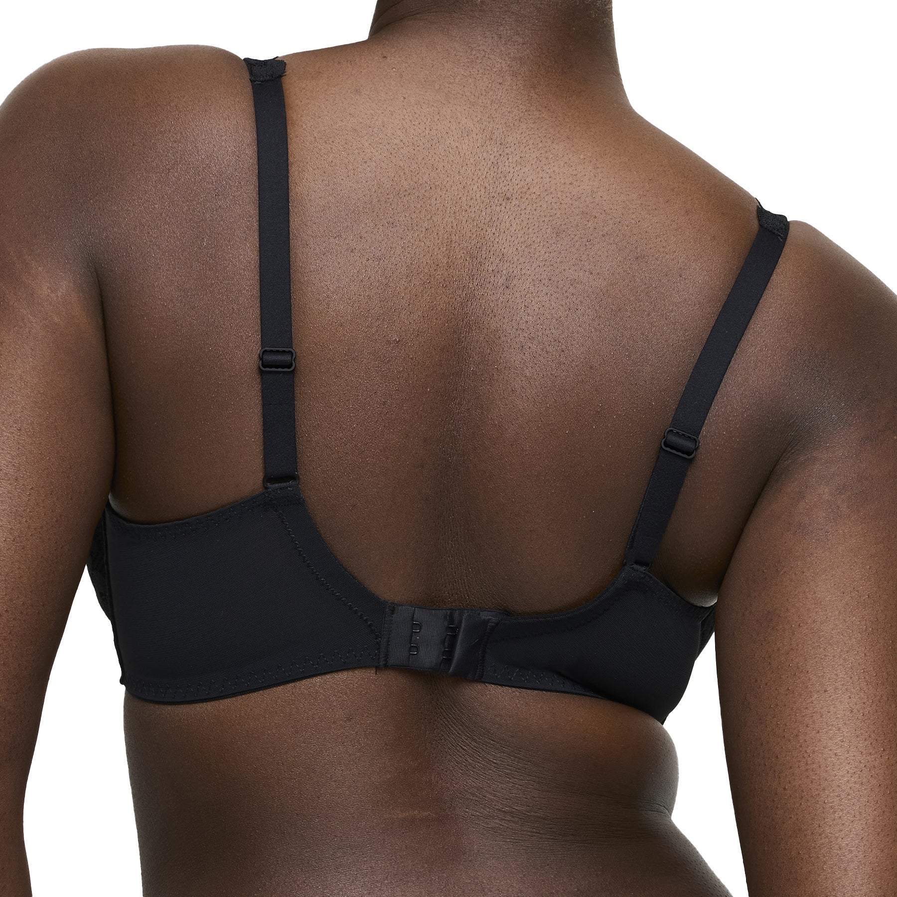 Back view of black bra on model with adjustable straps and hook closure.