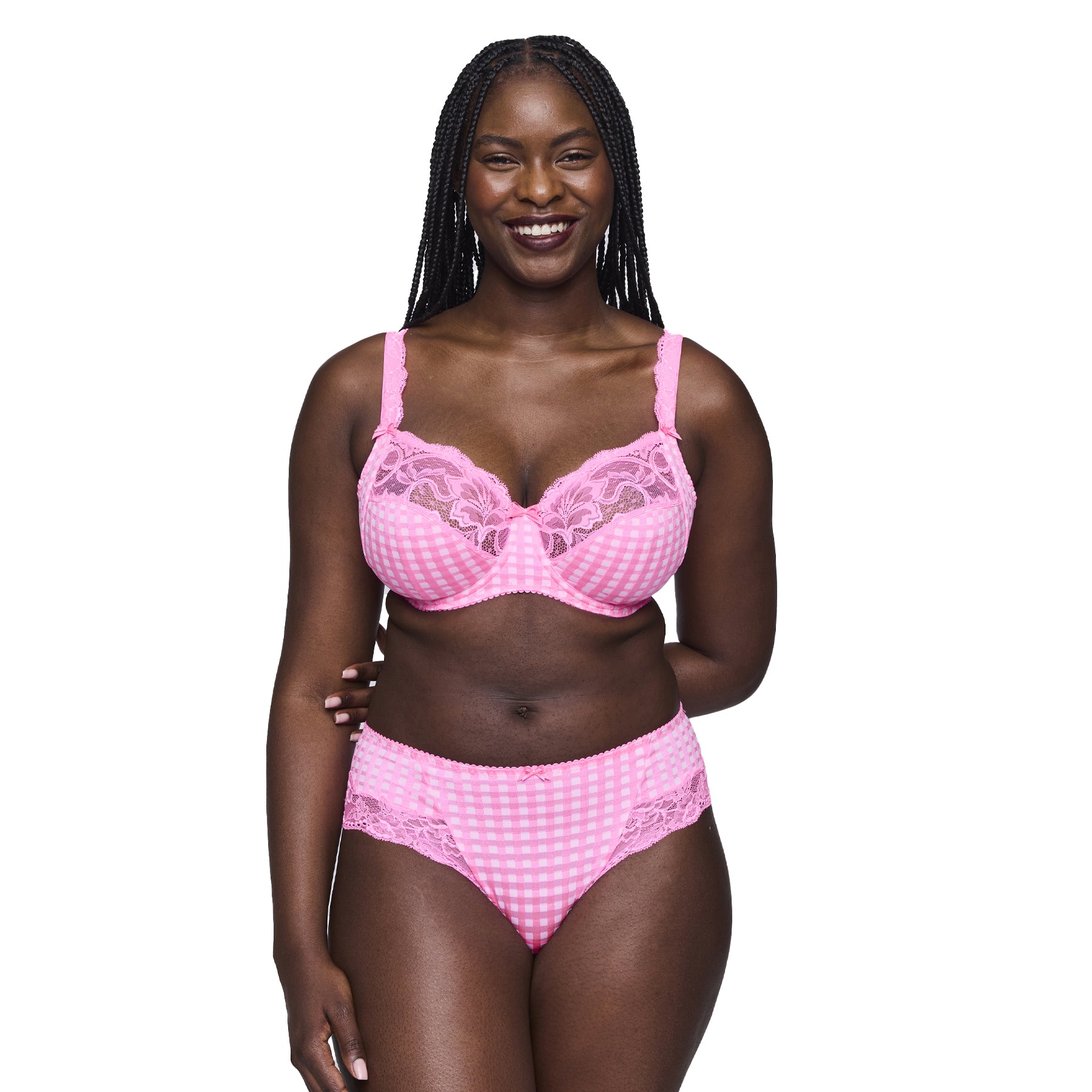 Smiling woman in a pink gingham and lace bra and high-waisted panty set.