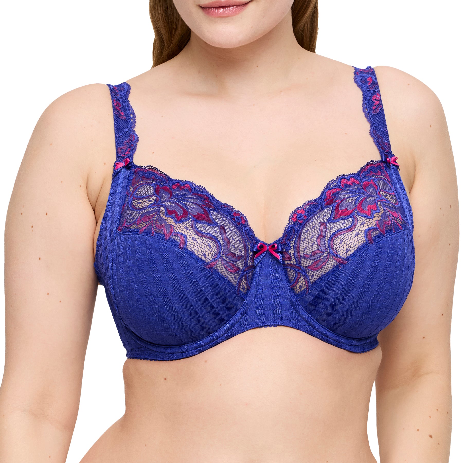 Close-up of blue bra with floral fuchsia lace and centre bow on model.