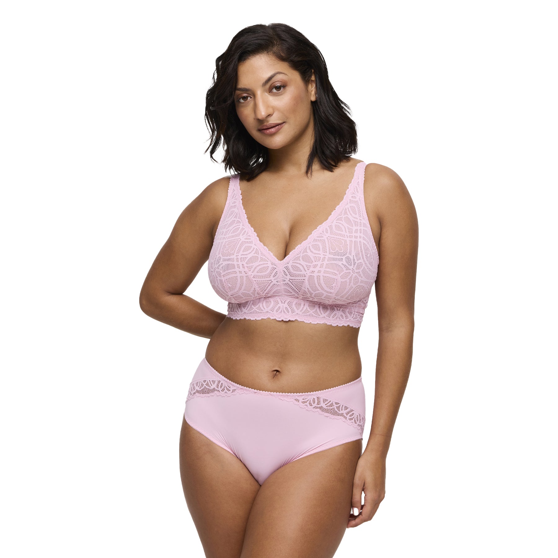 Woman wearing a soft pink lace wireless bralette and matching high-waist brief, front view.
