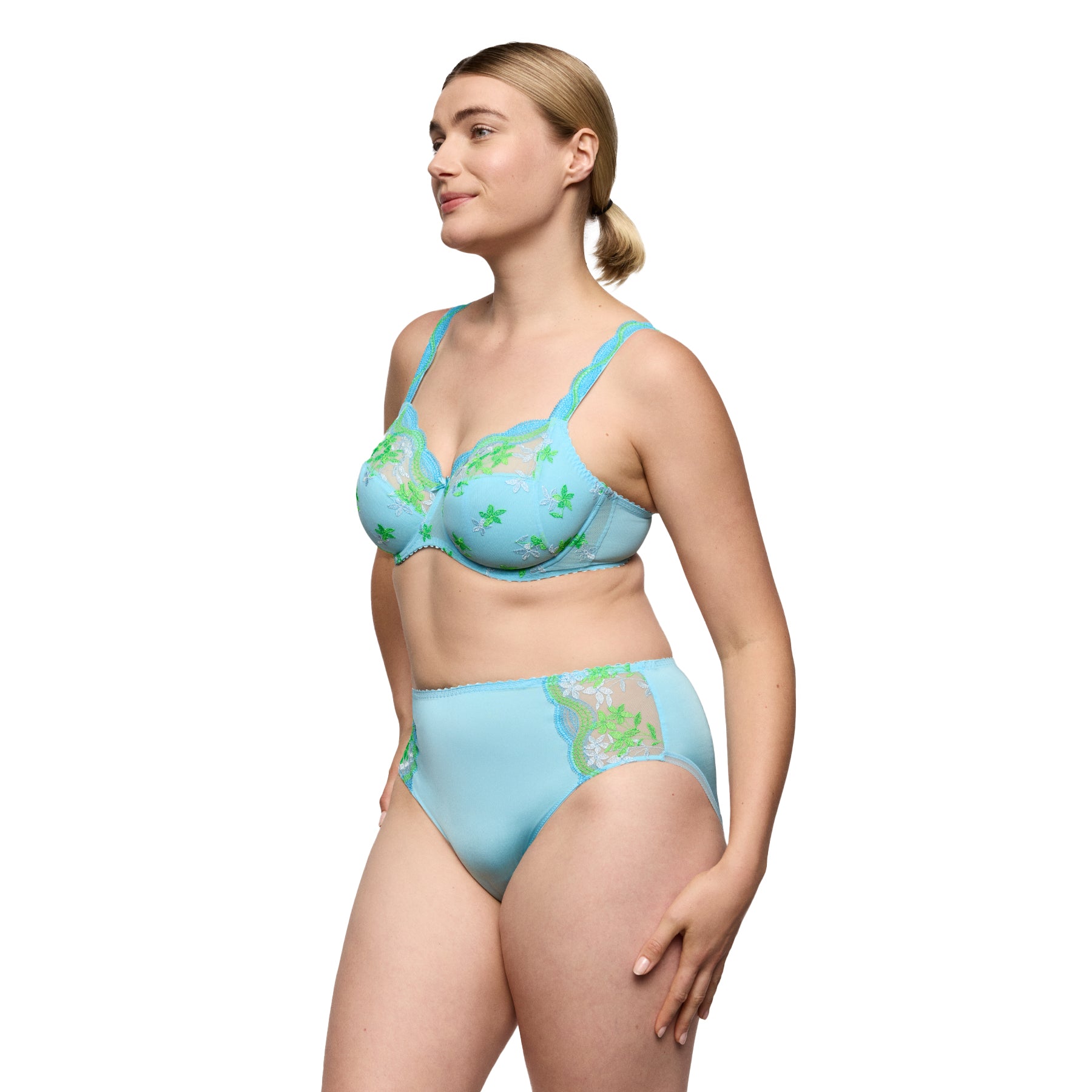 Light blue full cup bra and high-waist brief set with green floral embroidery on model, side view