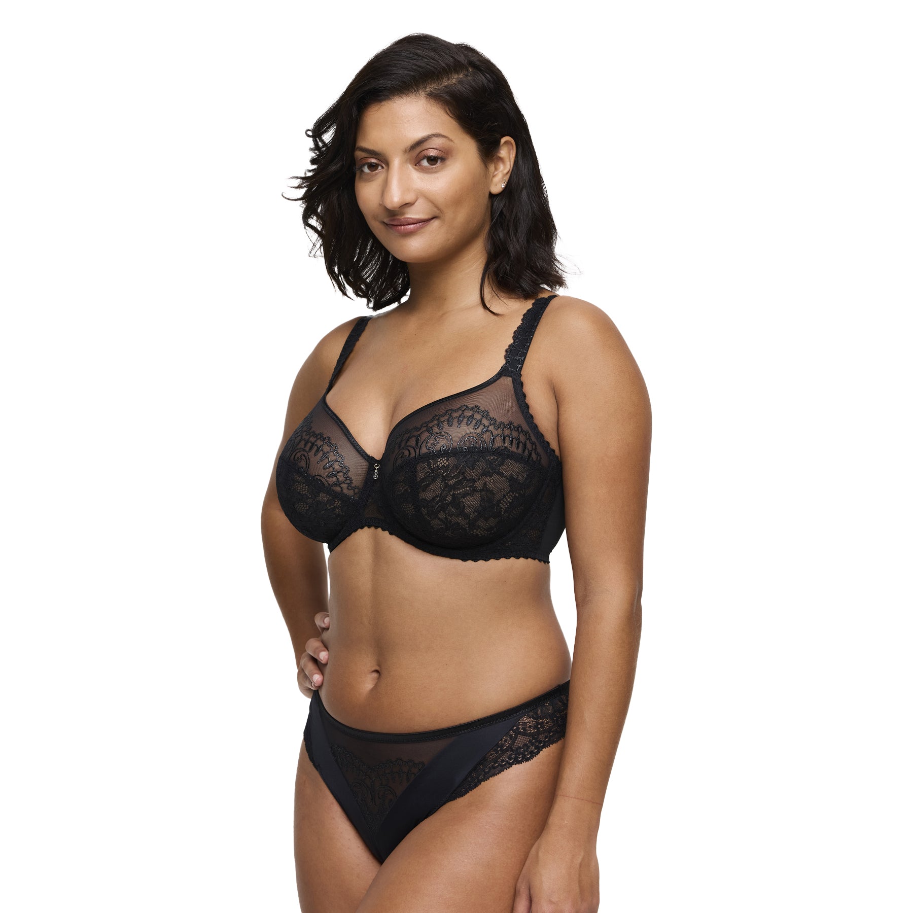 Model wearing black lace bra with sheer mesh and scalloped detailing, front view.