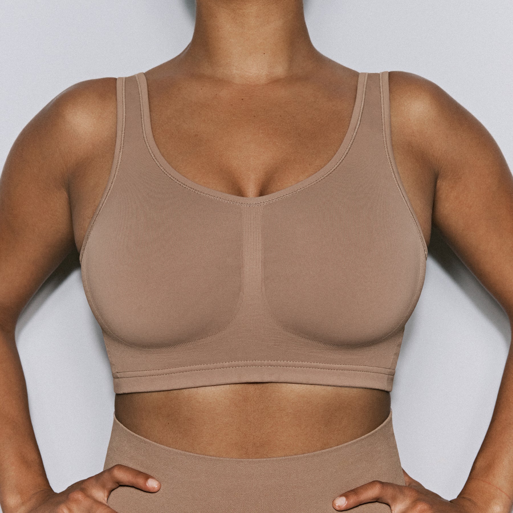 Close-up front detail of mocha seamless wireless bra showing smooth cups and invisible finish