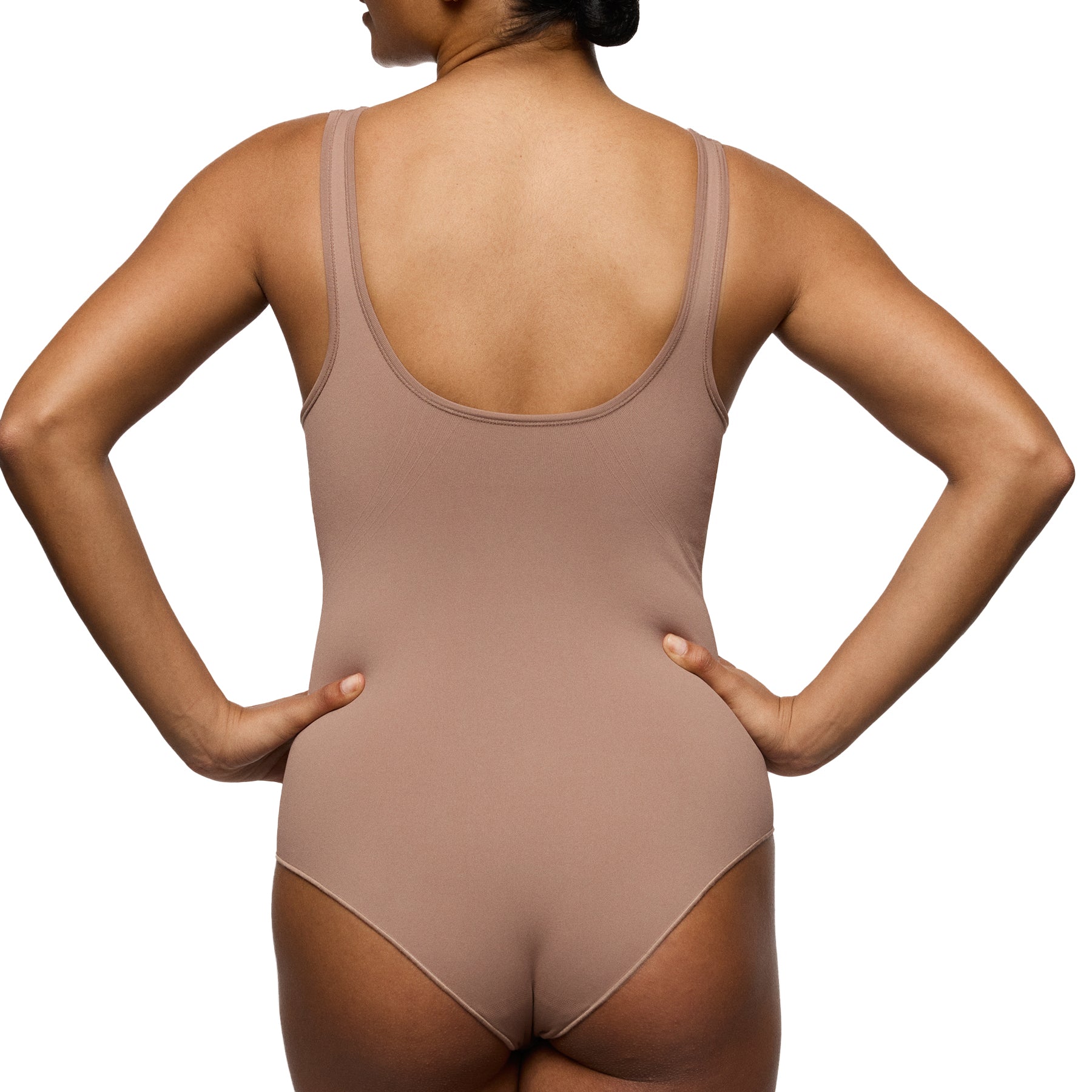 Back view of model wearing mocha seamless minimizer bodysuit with wide straps and smoothing back panel