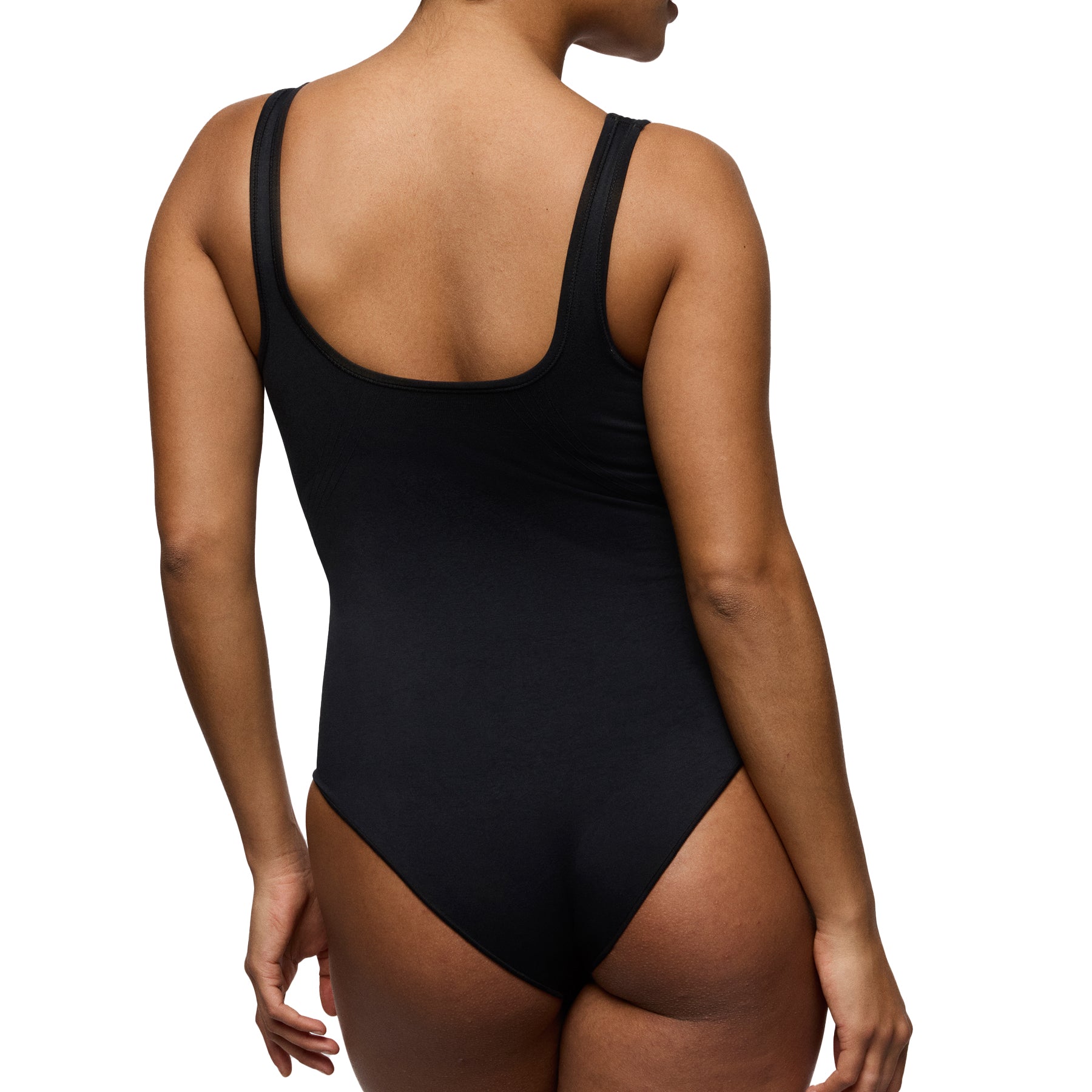 Back view of model wearing black seamless minimizer bodysuit with wide straps and smoothing back