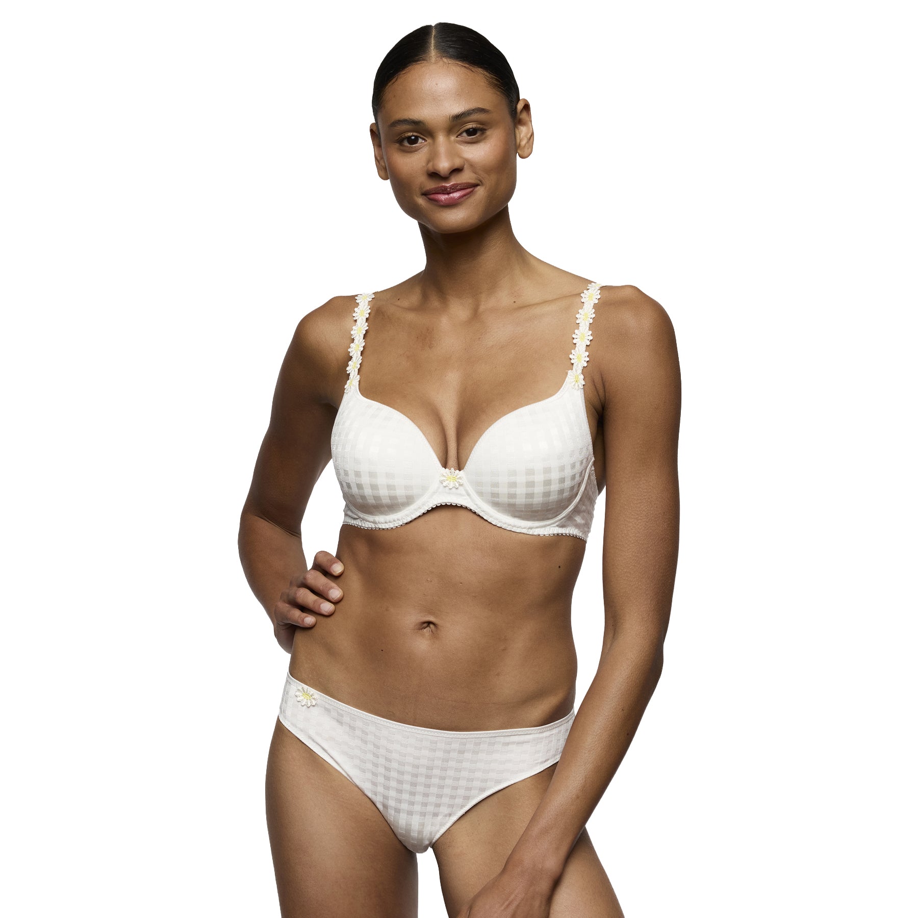 Full-body view of a model wearing an ivory underwire bra and matching brief with a subtle check texture and floral strap details.