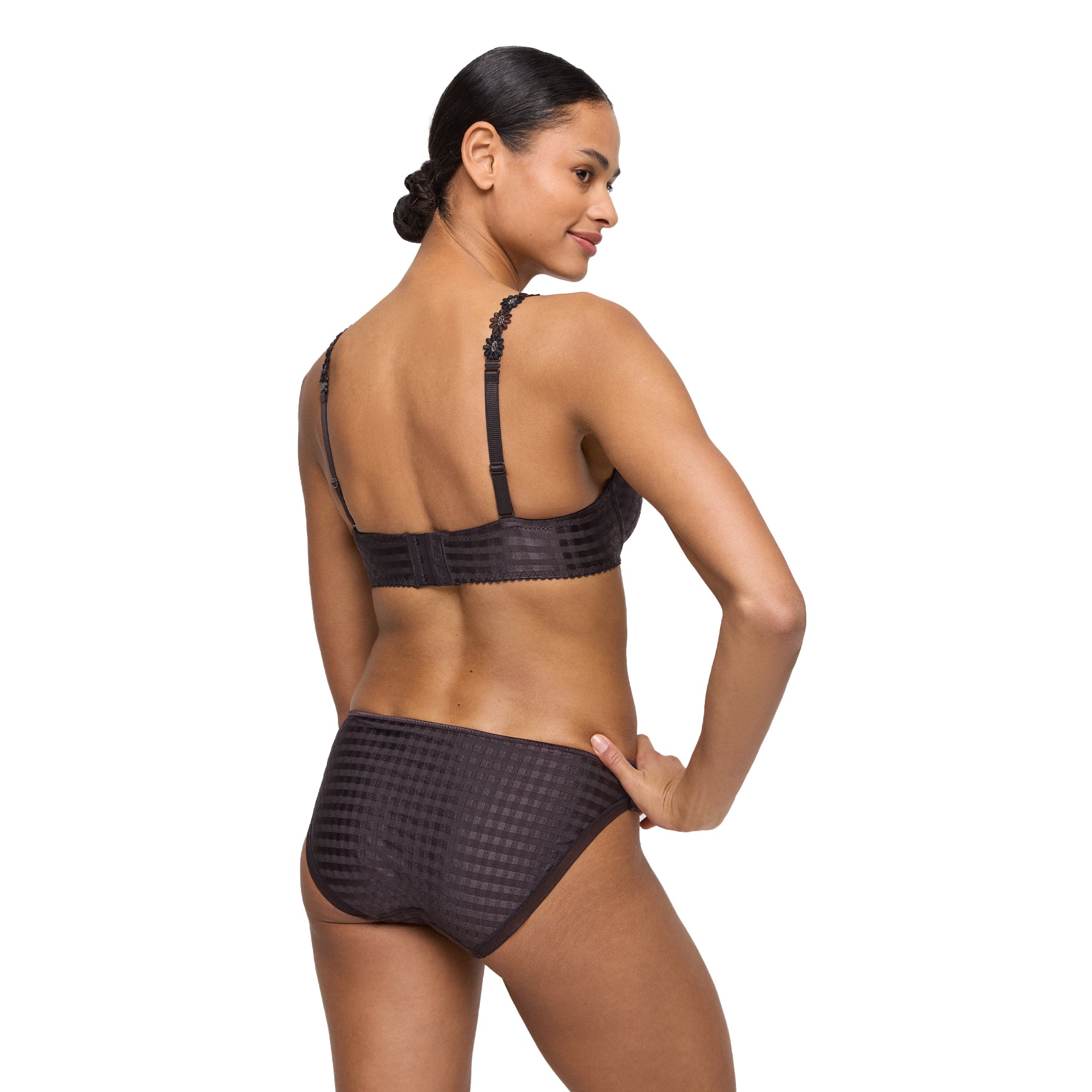 Woman wearing a matching check-pattern bra and bikini brief set, back view.
