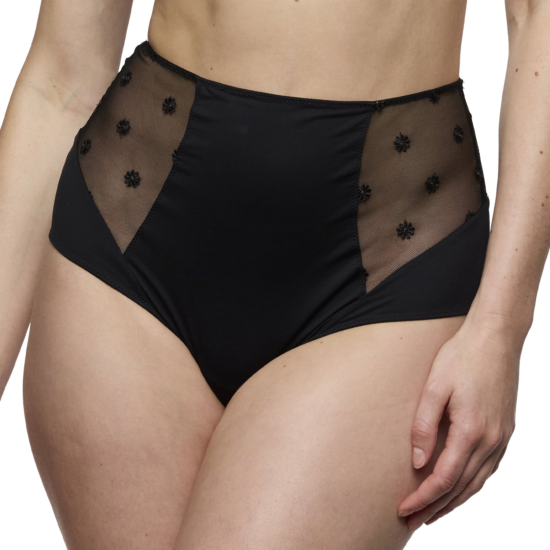 Close-up front view of a black high-waisted brief with smooth fabric and sheer embroidered mesh inserts.