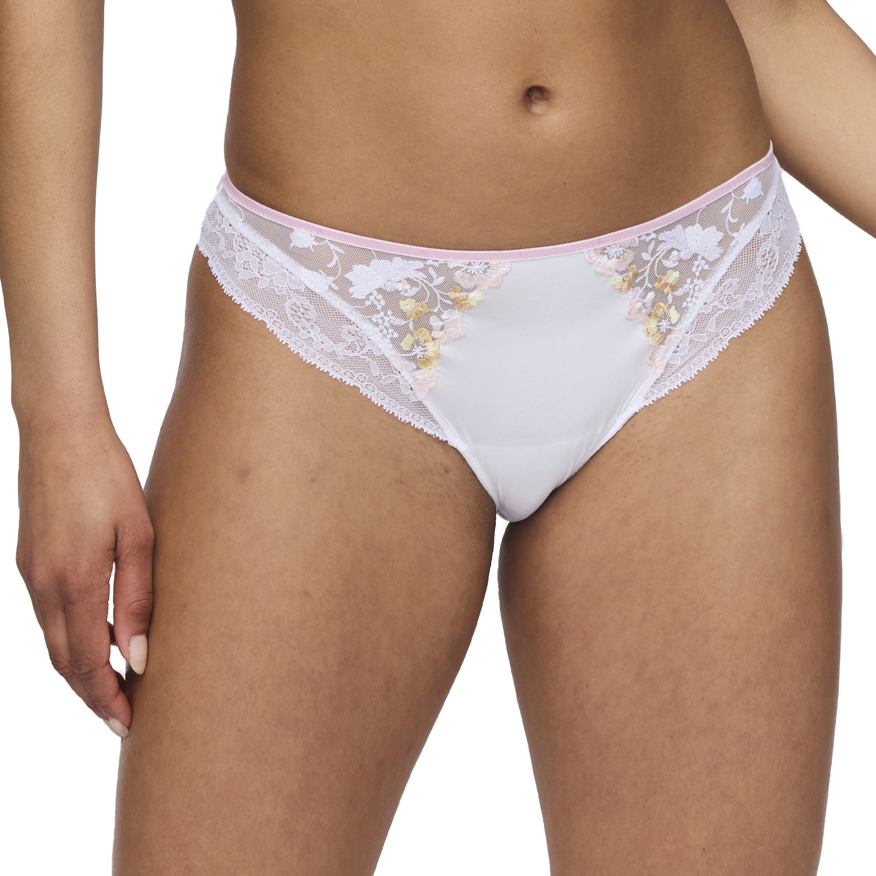 Front view of a woman modeling the white panty with pastel floral embroidery and lace trim, highlighting the feminine and elegant details.