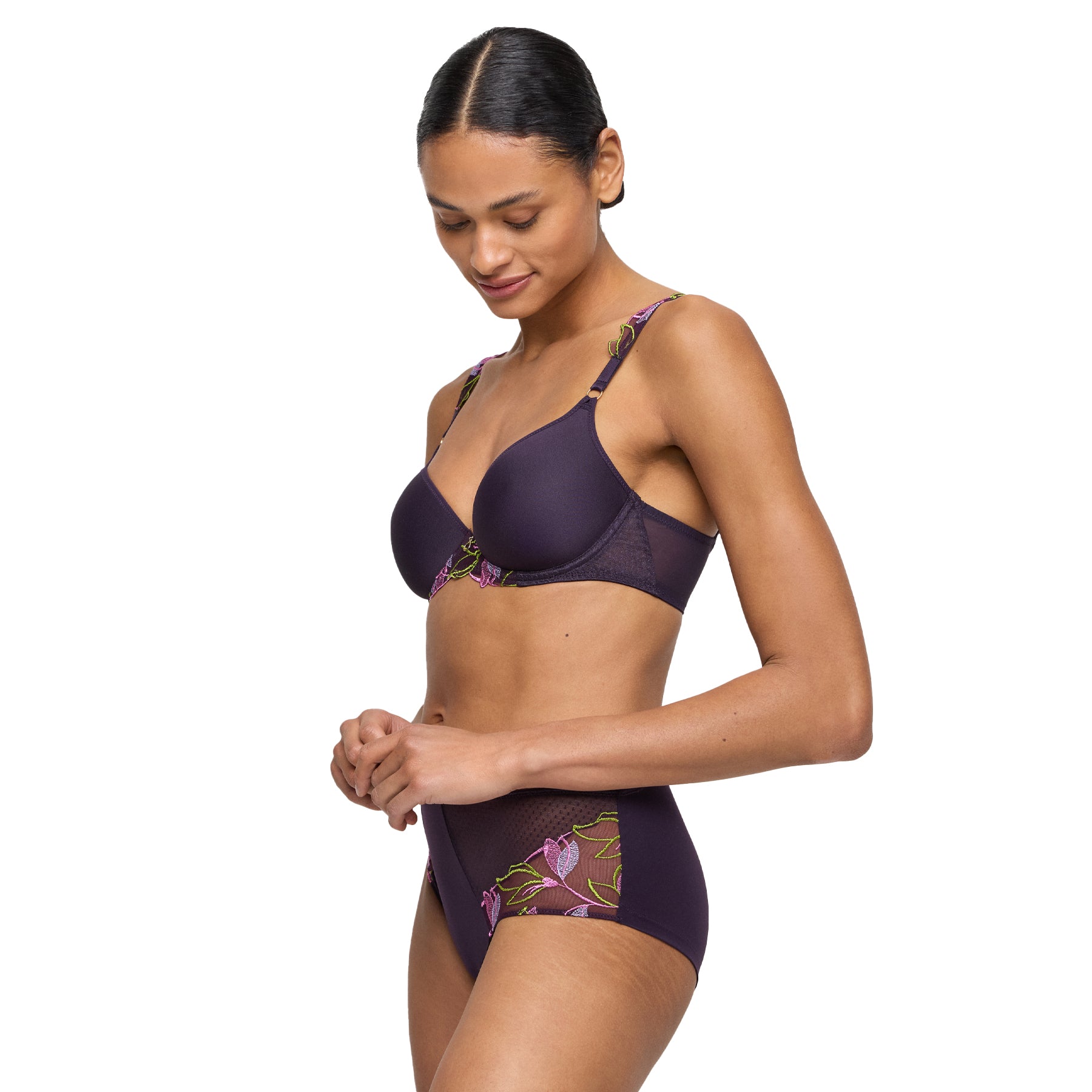 Model wearing matching plum embroidered bra and high-waisted brief set with mesh panels and floral accents