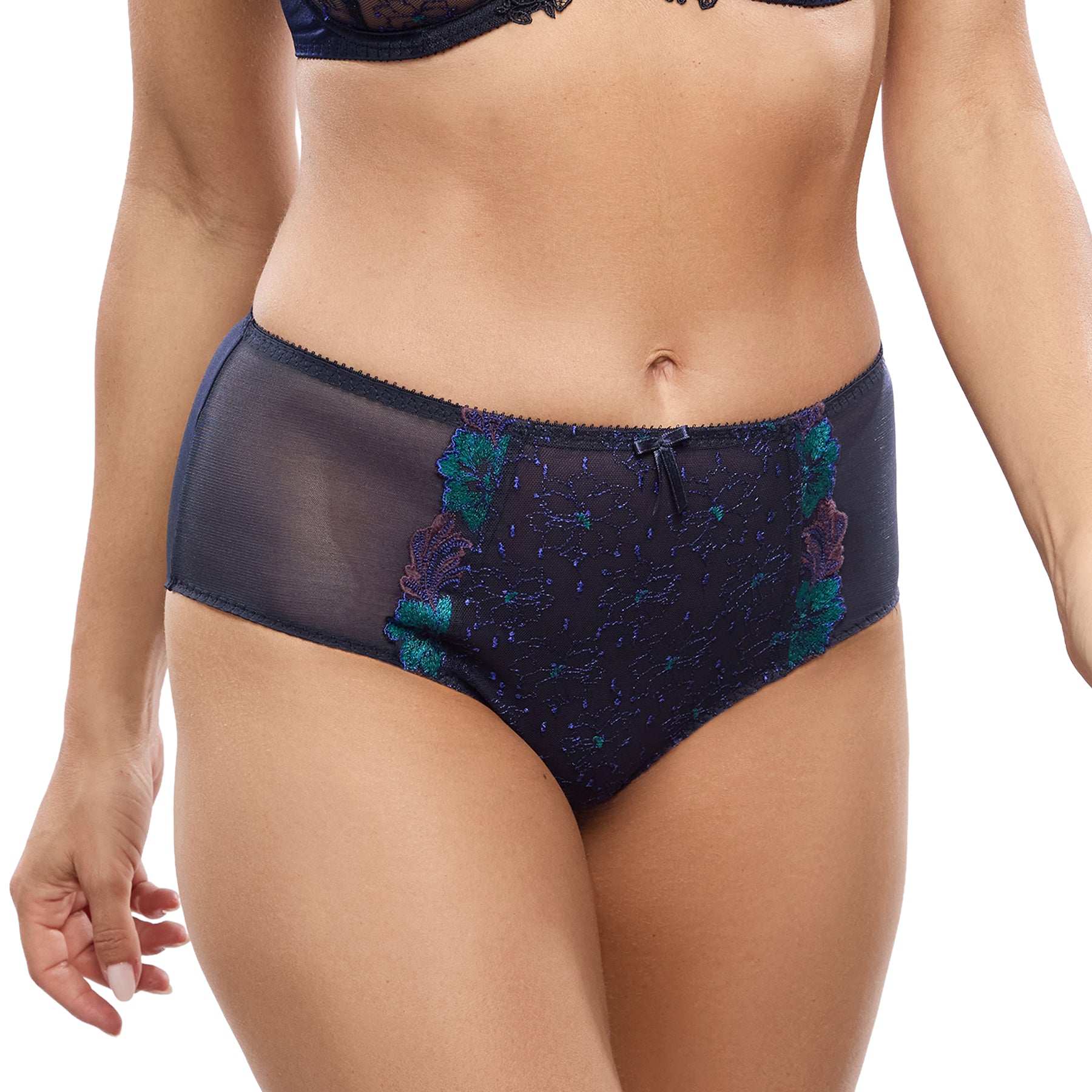 Model wearing the Empreinte Clea High-Waist Brief in Mystic Blue with sheer side panels and teal floral embroidery.