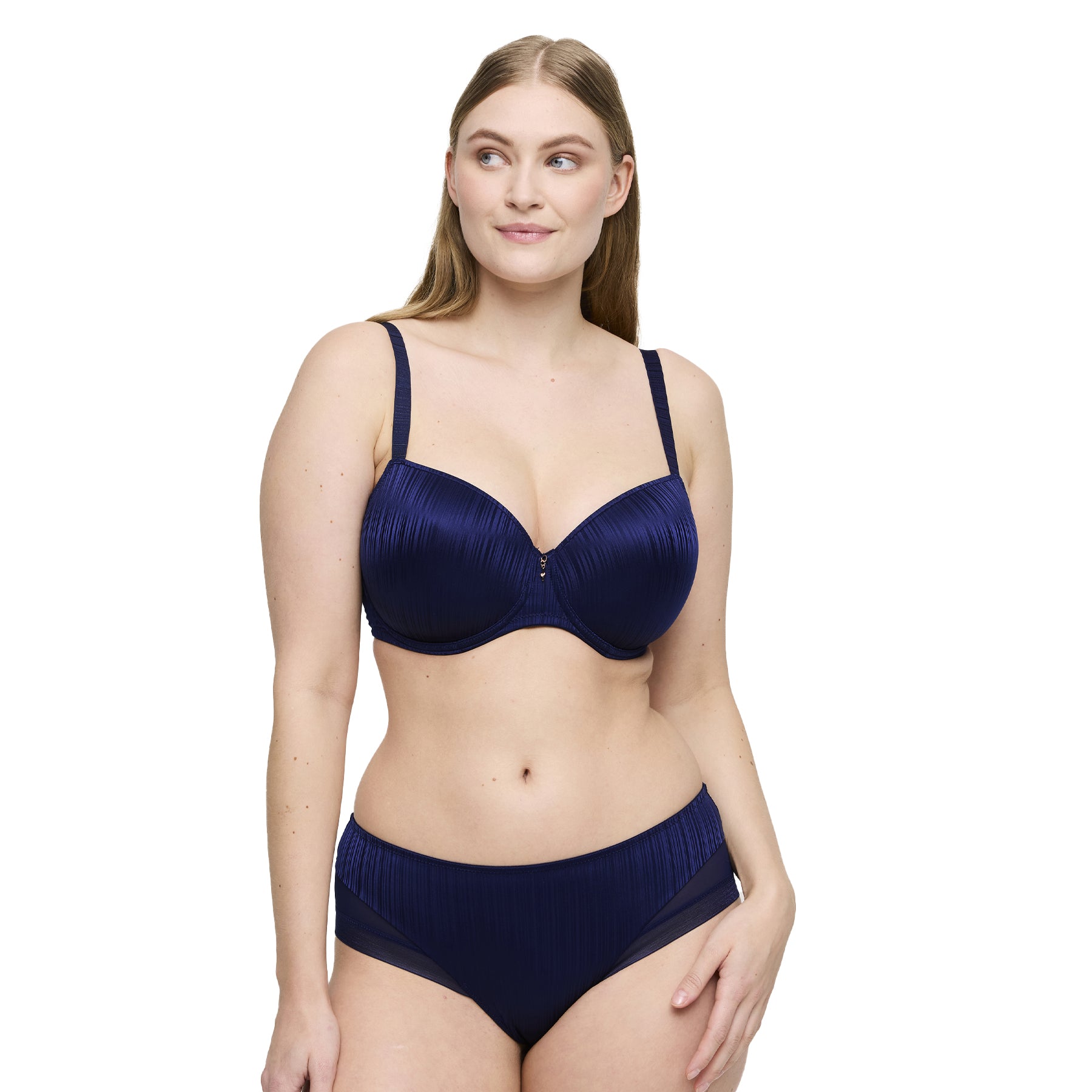 Woman wearing a sapphire blue bra and matching panties with pleated fabric and sheer mesh panels.