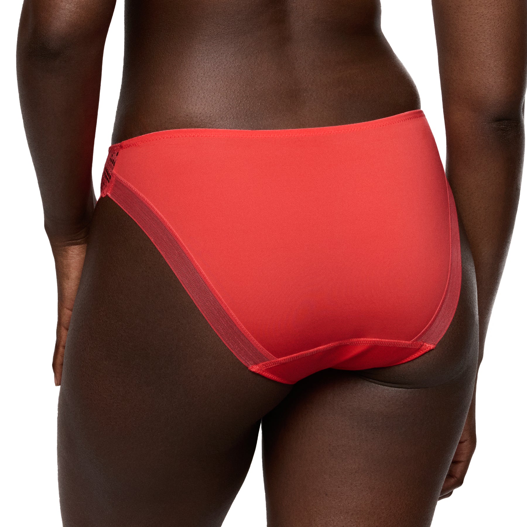 Back view of coral mid-rise brief on model, showing smooth full-coverage back and clean seamless finish.