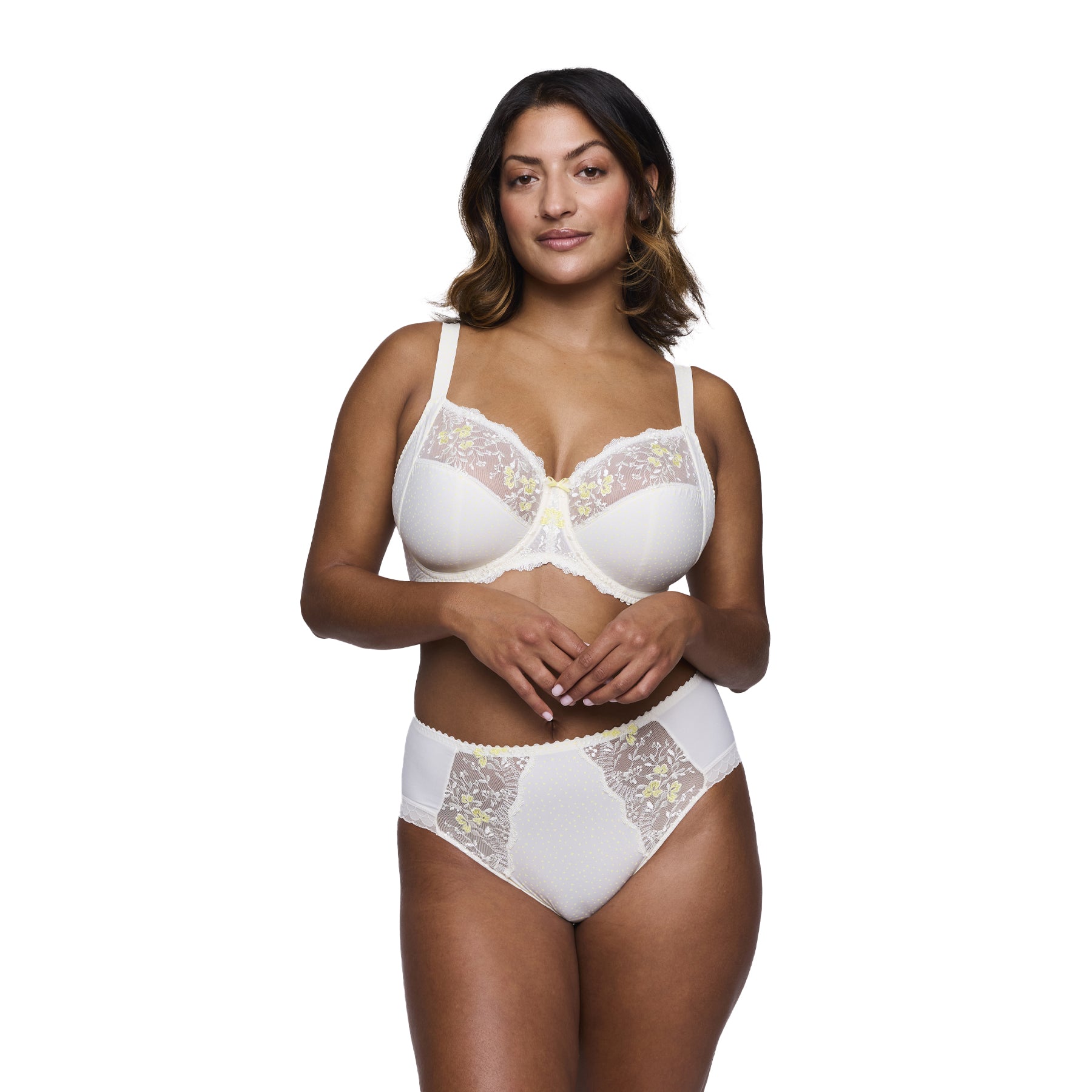 Model wearing a high-waisted brief with floral lace panels and soft ivory fabric, paired with matching embroidered bra.