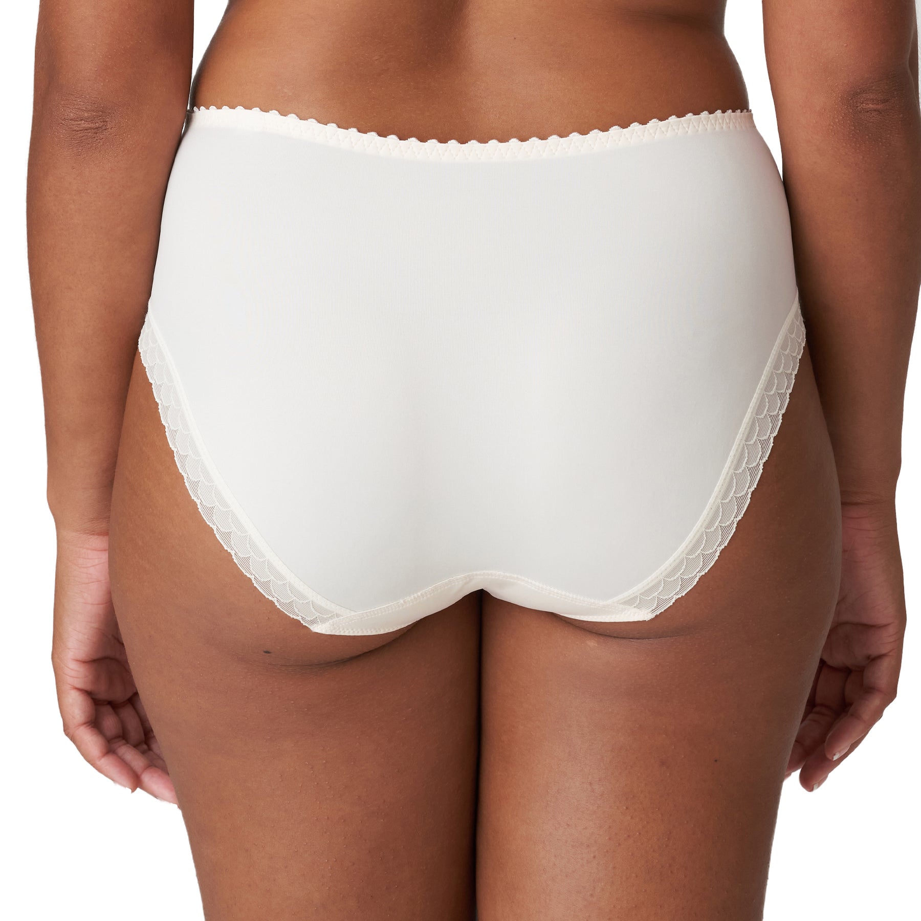 Back view on model showcasing full coverage ivory brief with scalloped trim and seamless back panel.