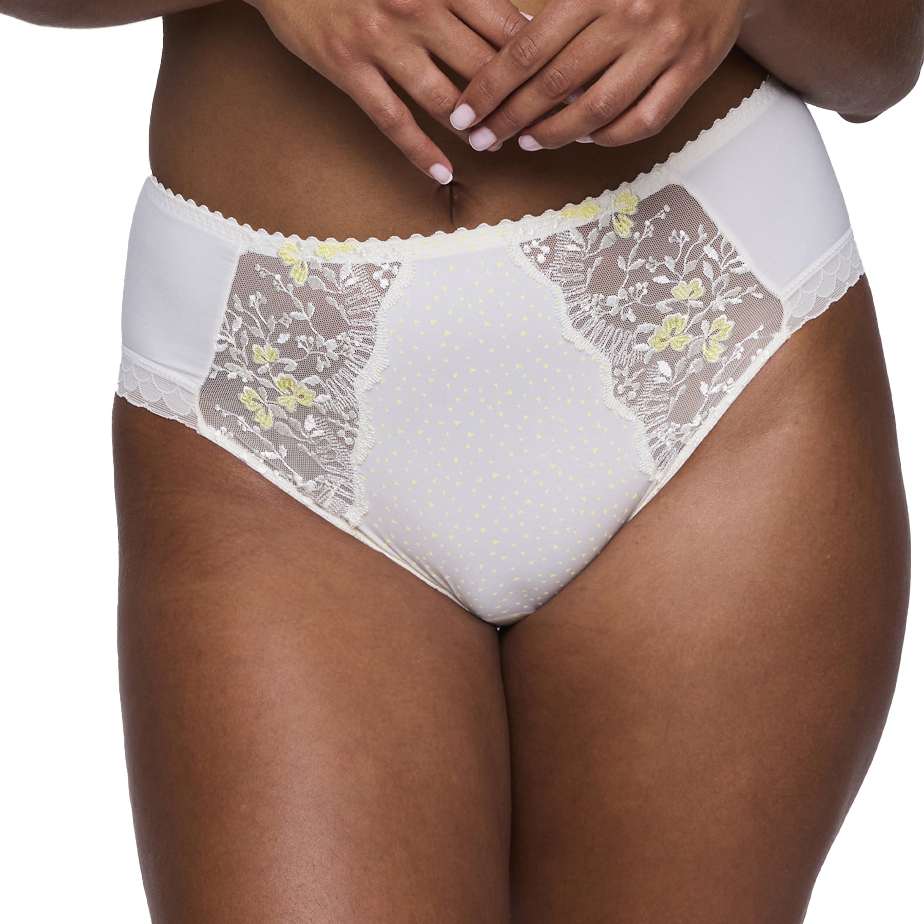 Close-up of the high-waisted brief on model, showing embroidered lace panels and triangle dot print at centre.