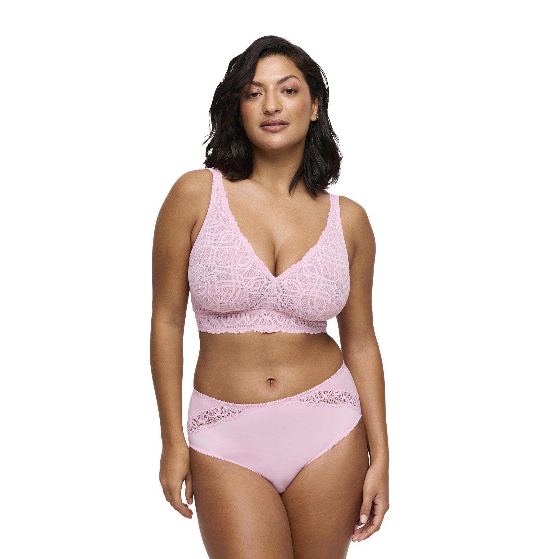 Woman wearing a soft pink high-waisted brief with lace detail and matching lace bralette, front view.