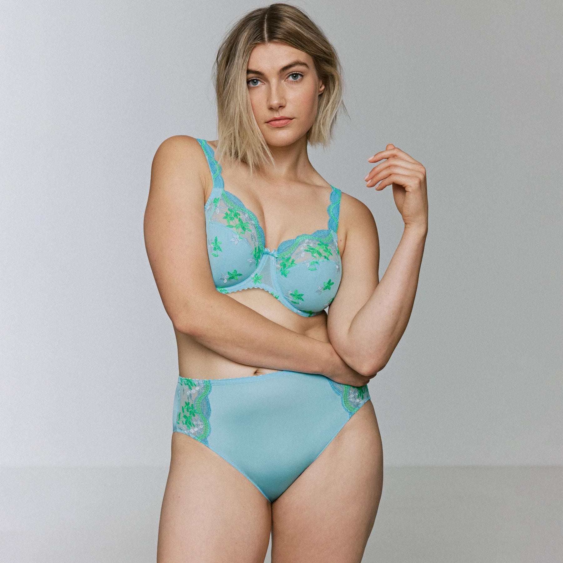 Light blue lingerie set with embroidered bra and matching high-waist brief on model