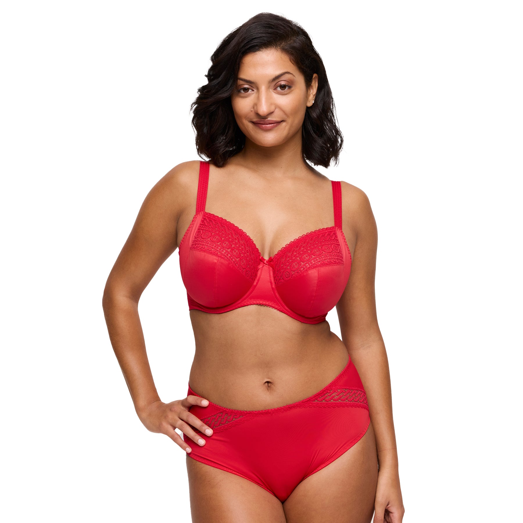 Woman wearing a red bra and panties set on a white background