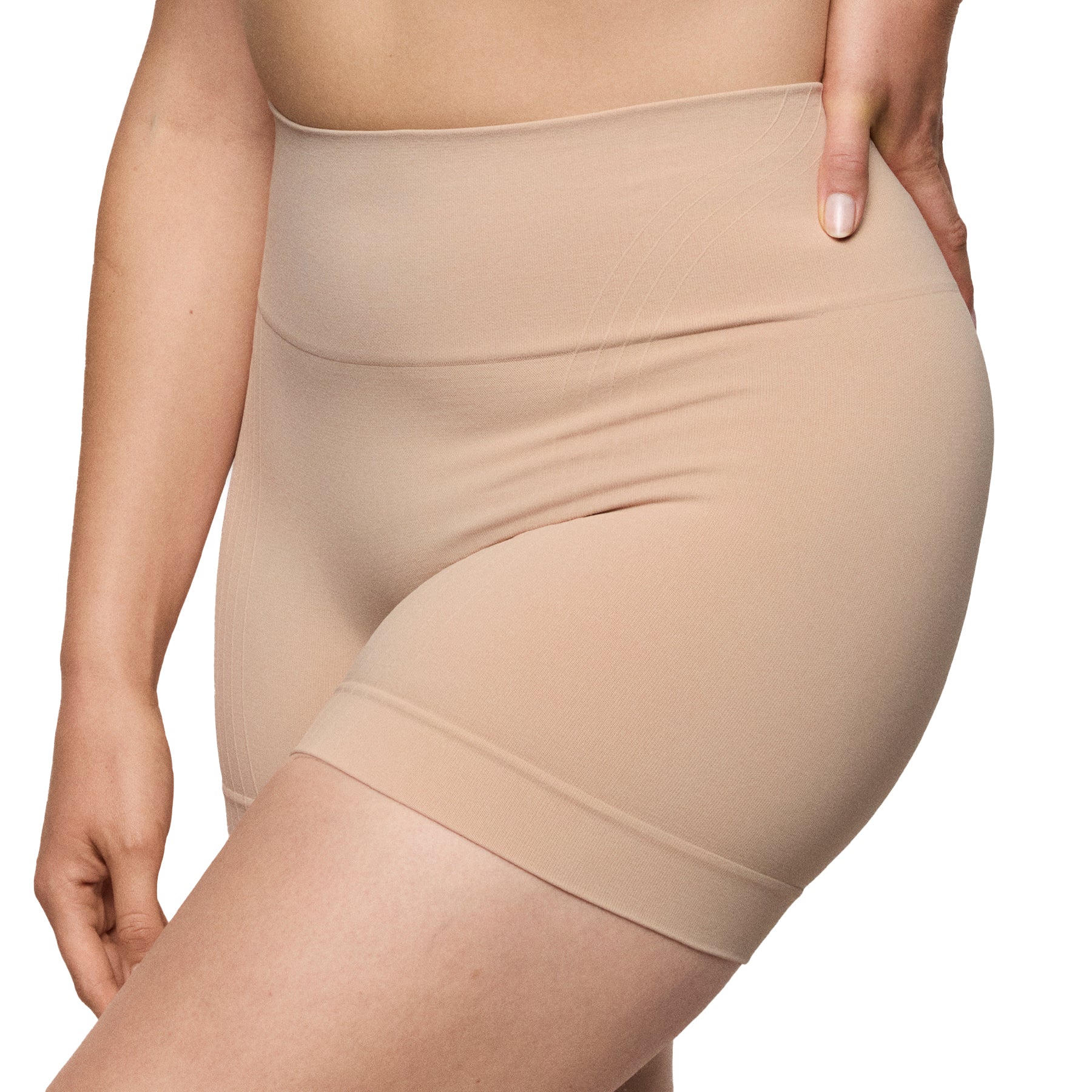 Side angled view of nude shaping shorts highlighting stretch fabric and thigh coverage