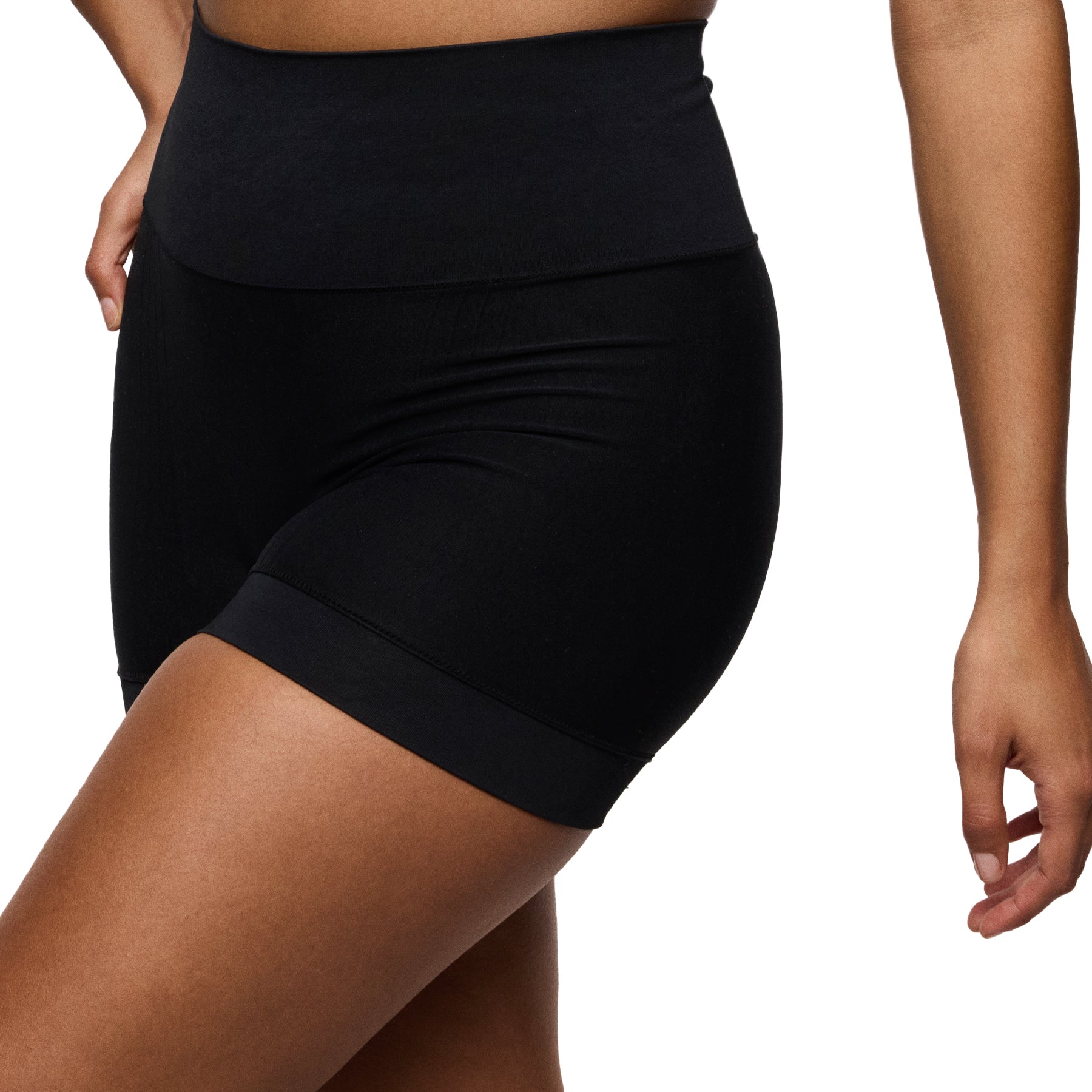 Side angled view of black high-waisted shaping shorts highlighting thigh coverage and seamless design