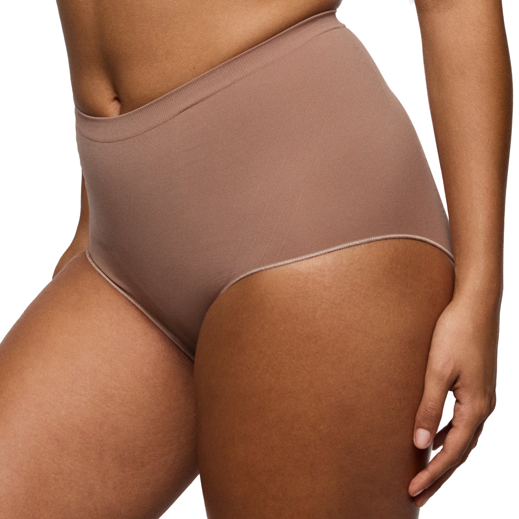 Side angle of seamless shaping panties in deep nude colour showing smooth finish and supportive waistband