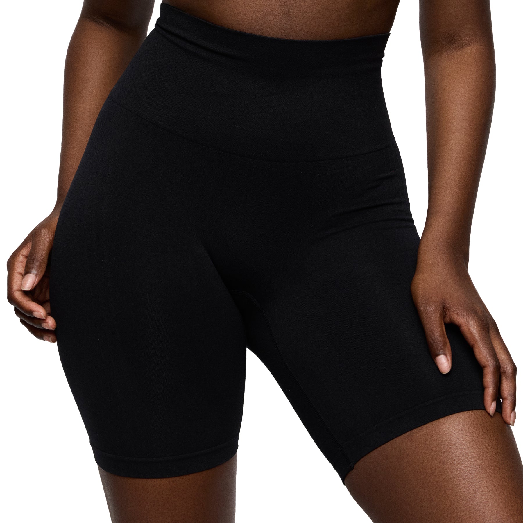 Black athletic shorts worn by a person on a white background