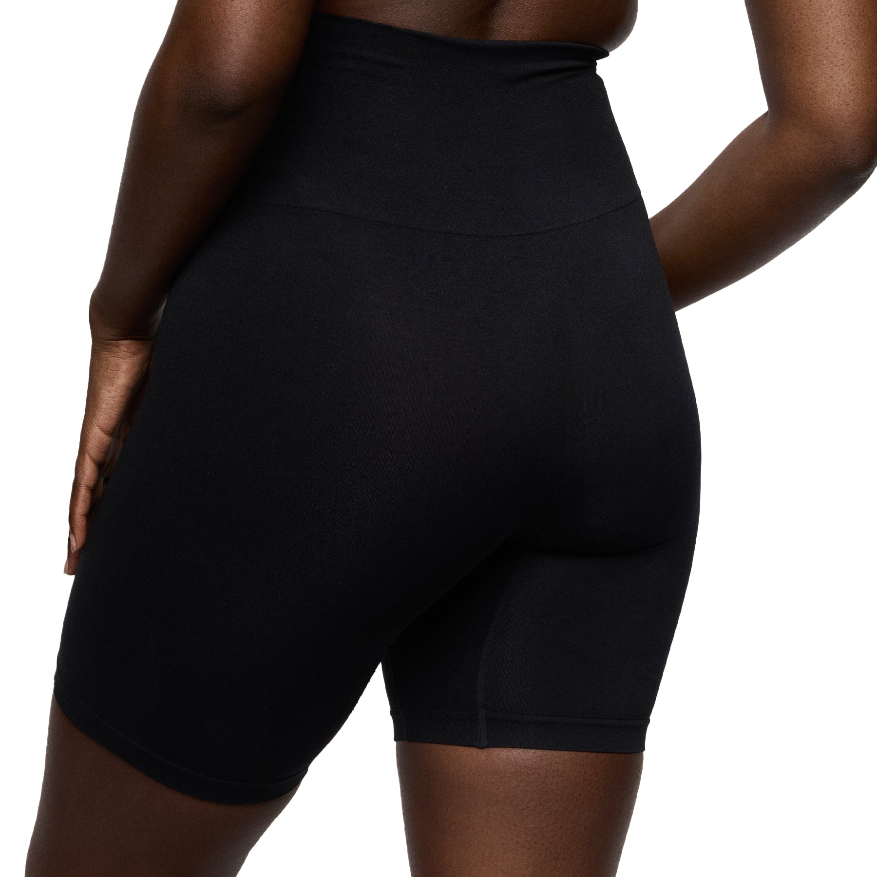Black high-waisted shorts worn by a person on a white background