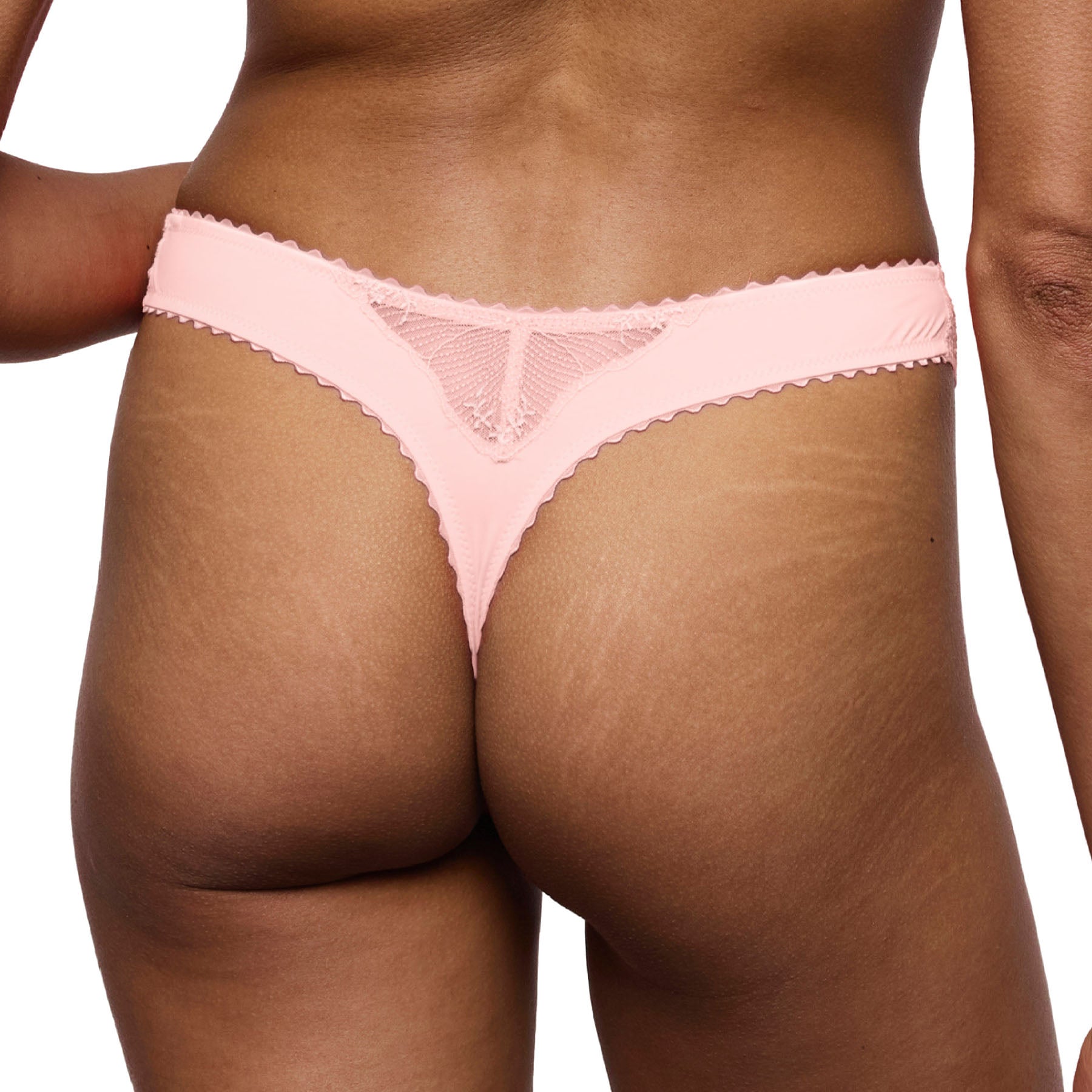 Back view of a blush pink thong with a smooth microfiber finish, delicate lace back detail, and comfortable stretch fit.