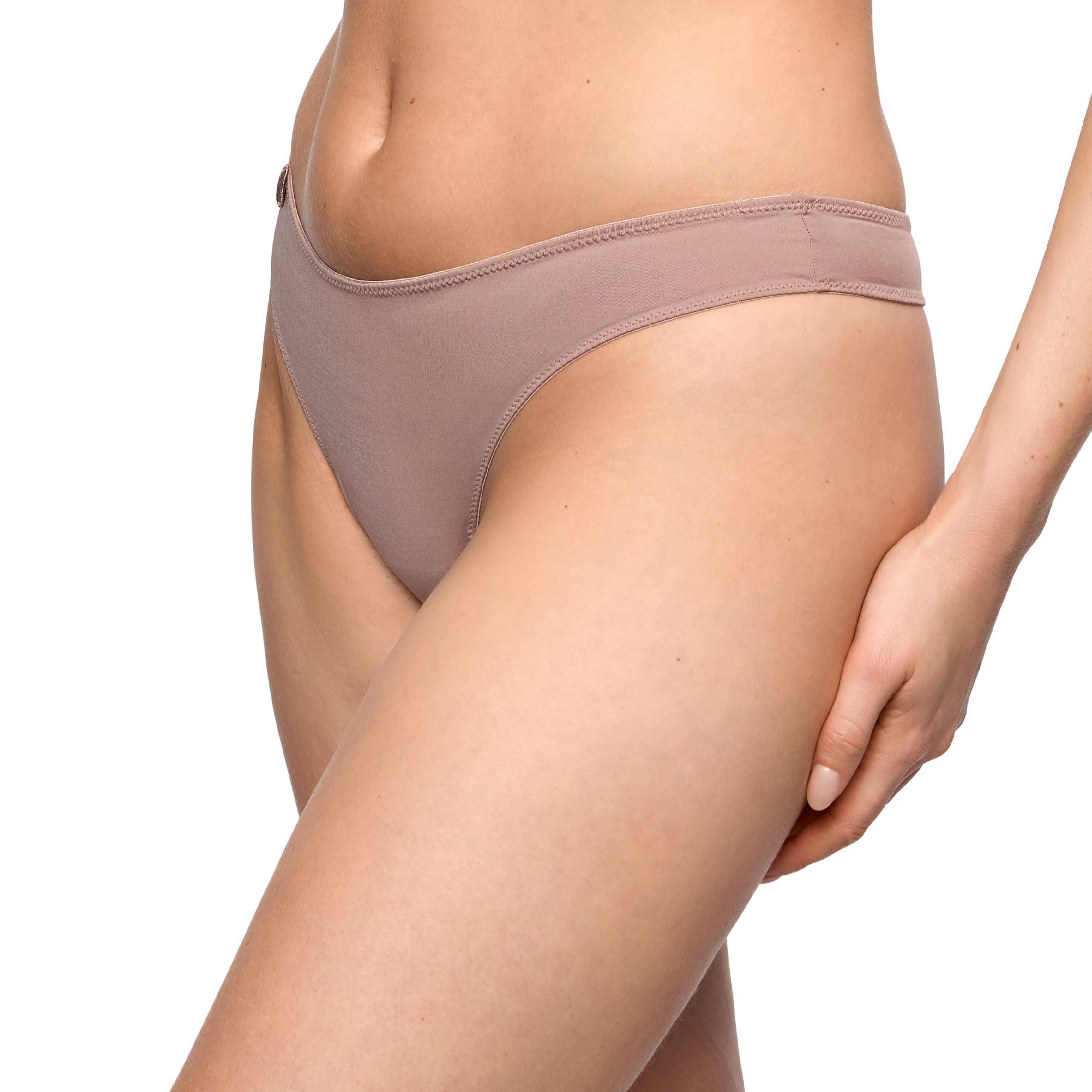 Cosmetic nude thong side view featuring a sleek low-rise silhouette and smooth everyday design.