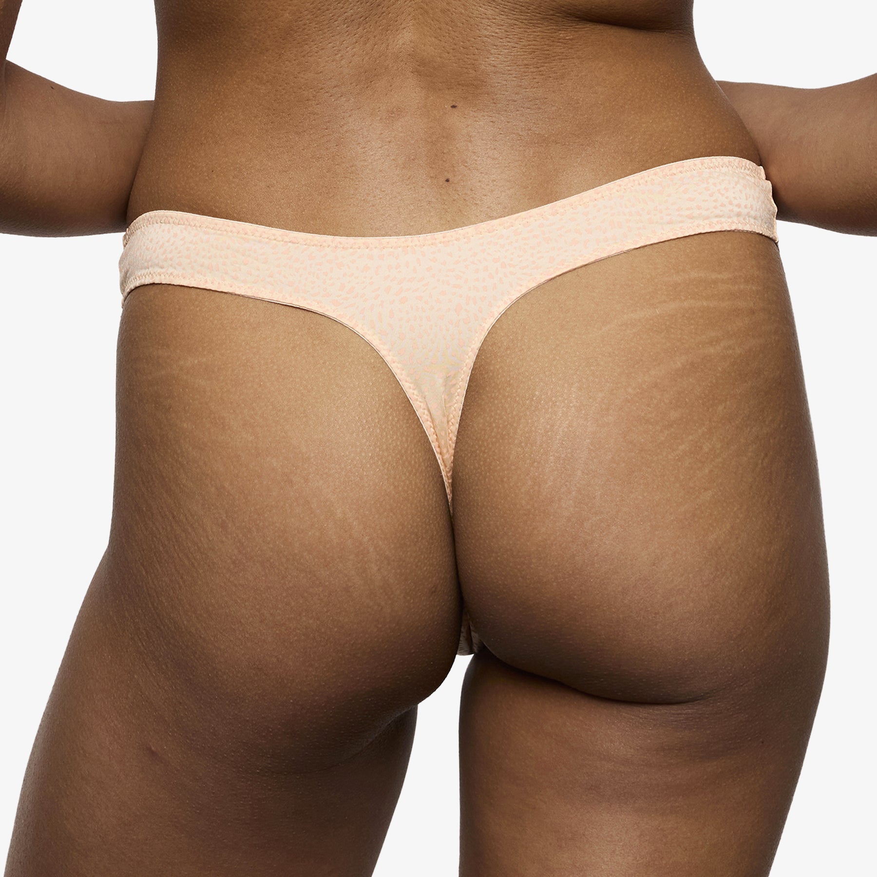 Peach thong back view with smooth stretch fabric and no visible lines