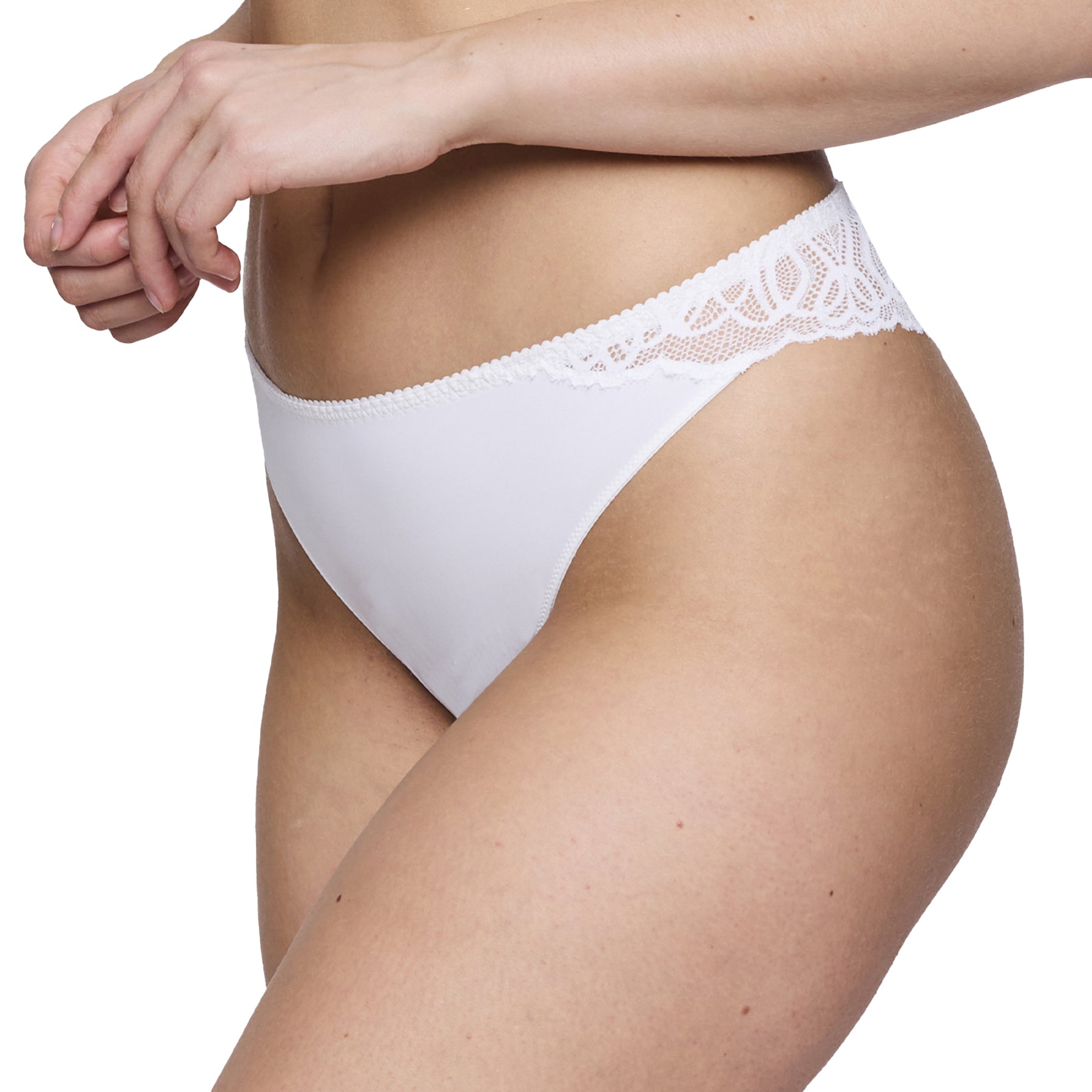 Side angle of the thong on a model, emphasizing the flattering cut and lace panel curving along the hips.