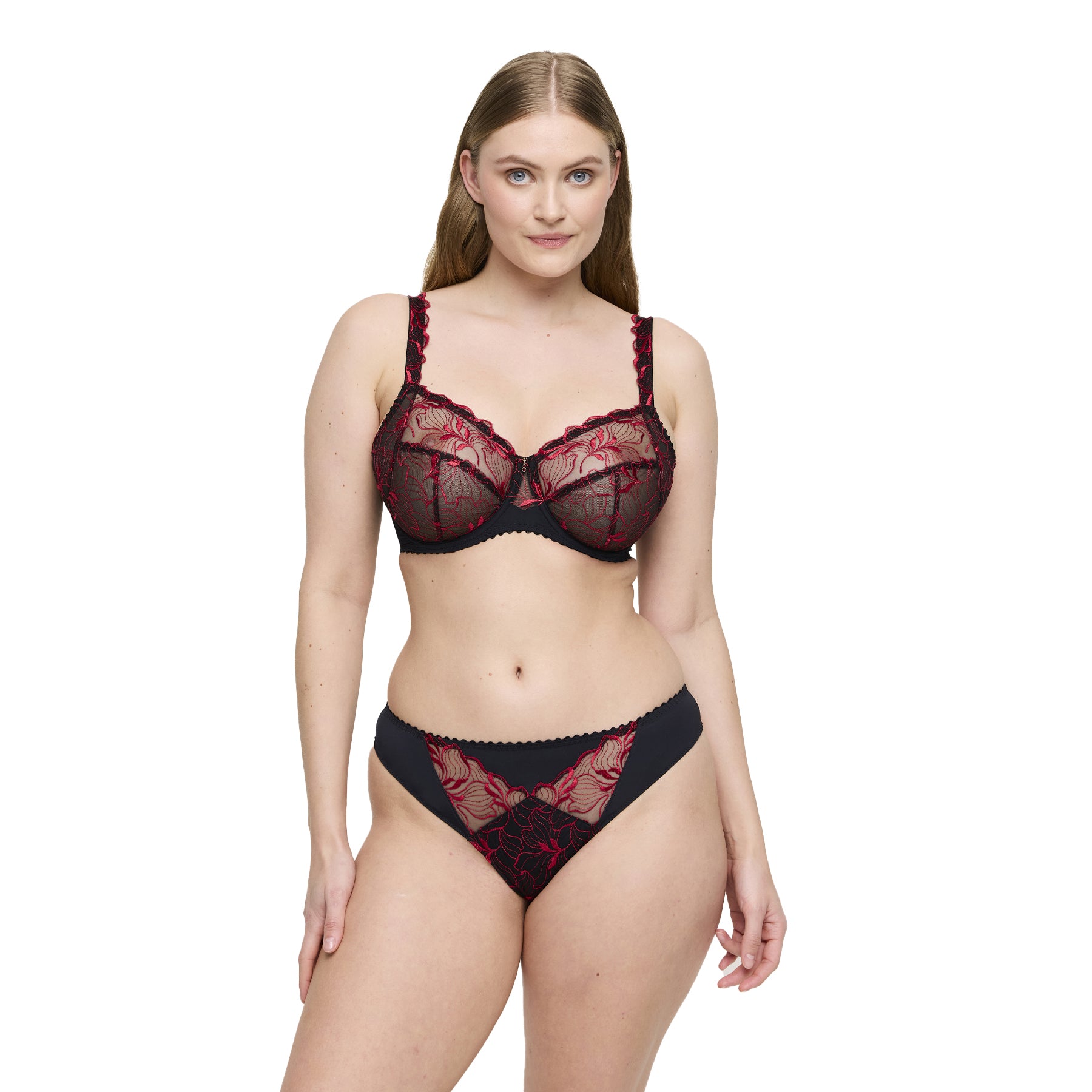 Model wearing black and red embroidered lace bra and thong set with sheer floral detailing.