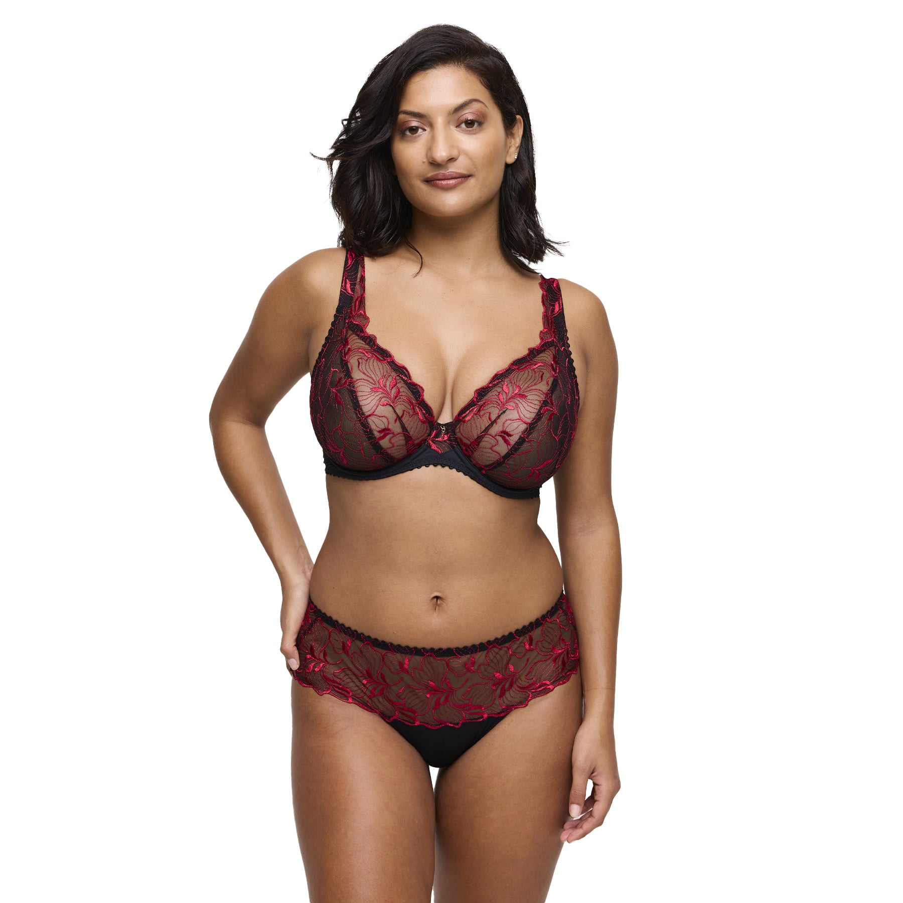 Model wearing black and red embroidered lace bra and brief set with sheer floral details.