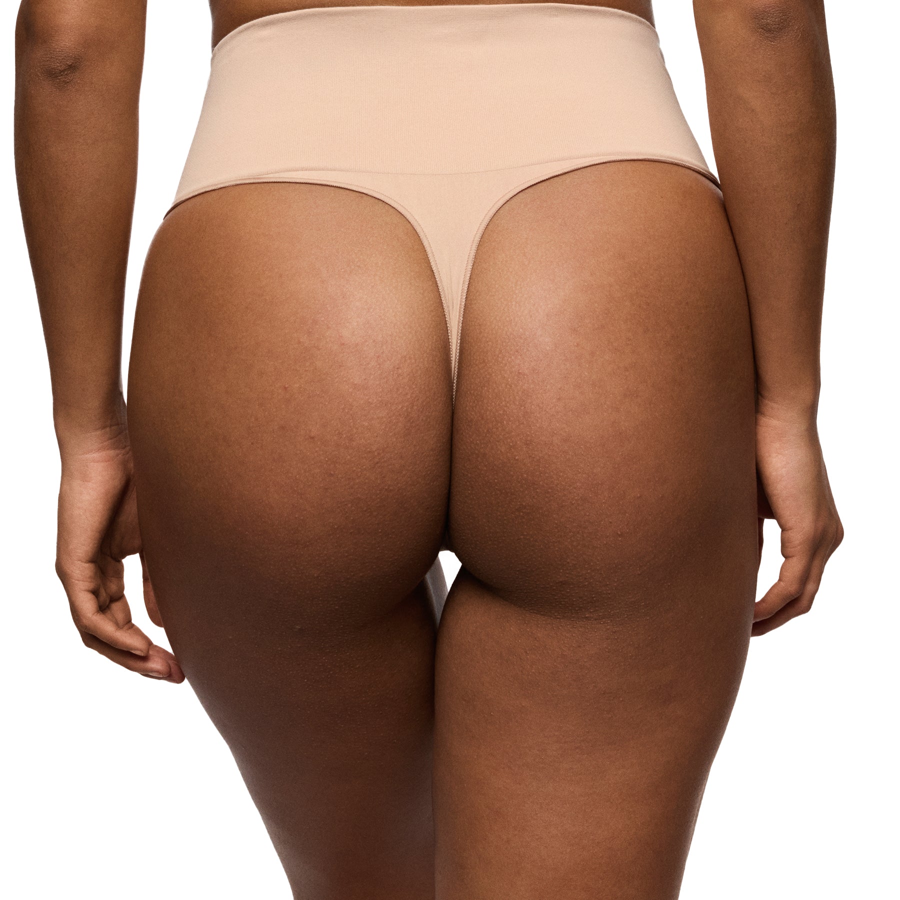 Beige underwear on a person against a white background