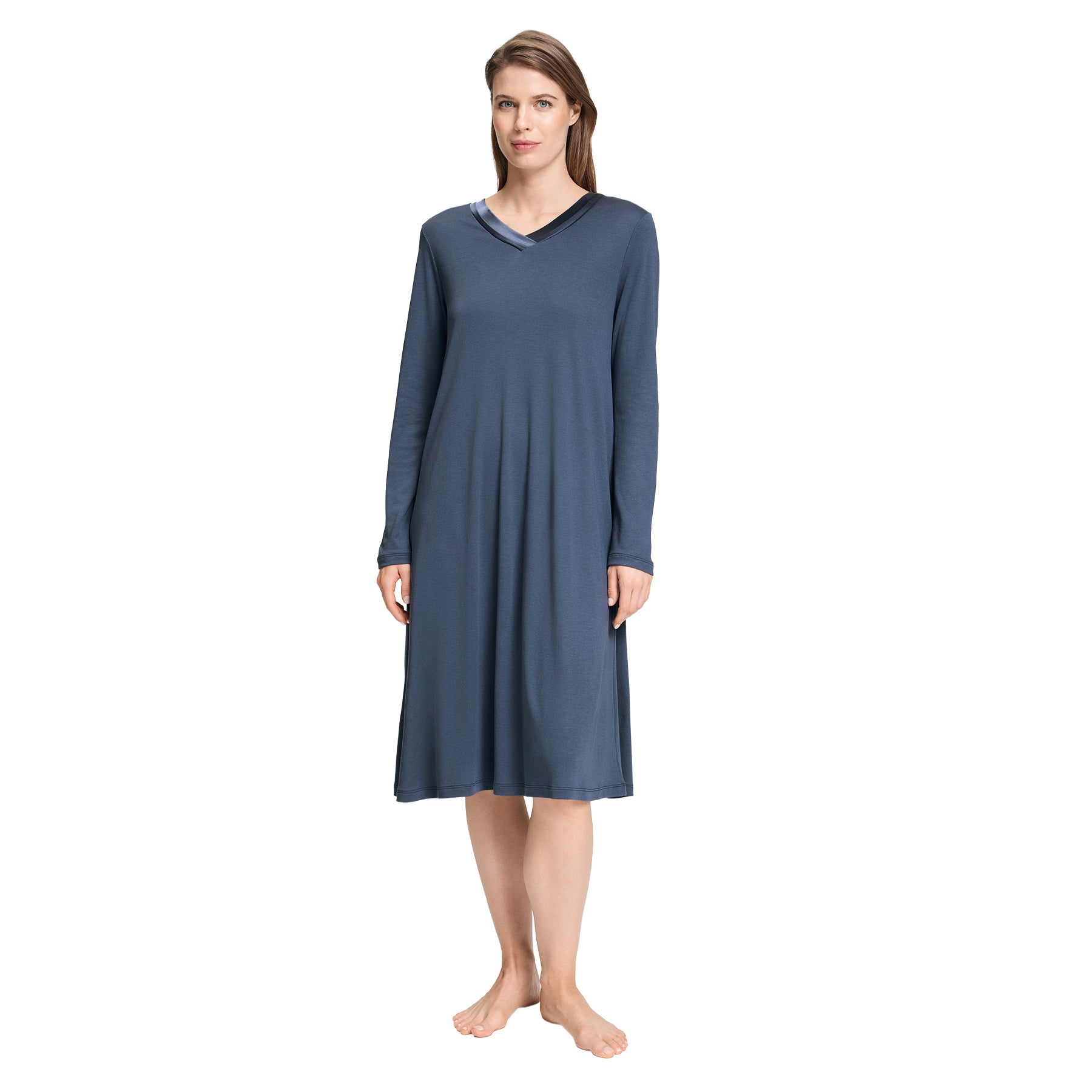 Woman wearing a blue long-sleeve nightgown with a satin-trimmed V-neckline and softly flared midi silhouette.