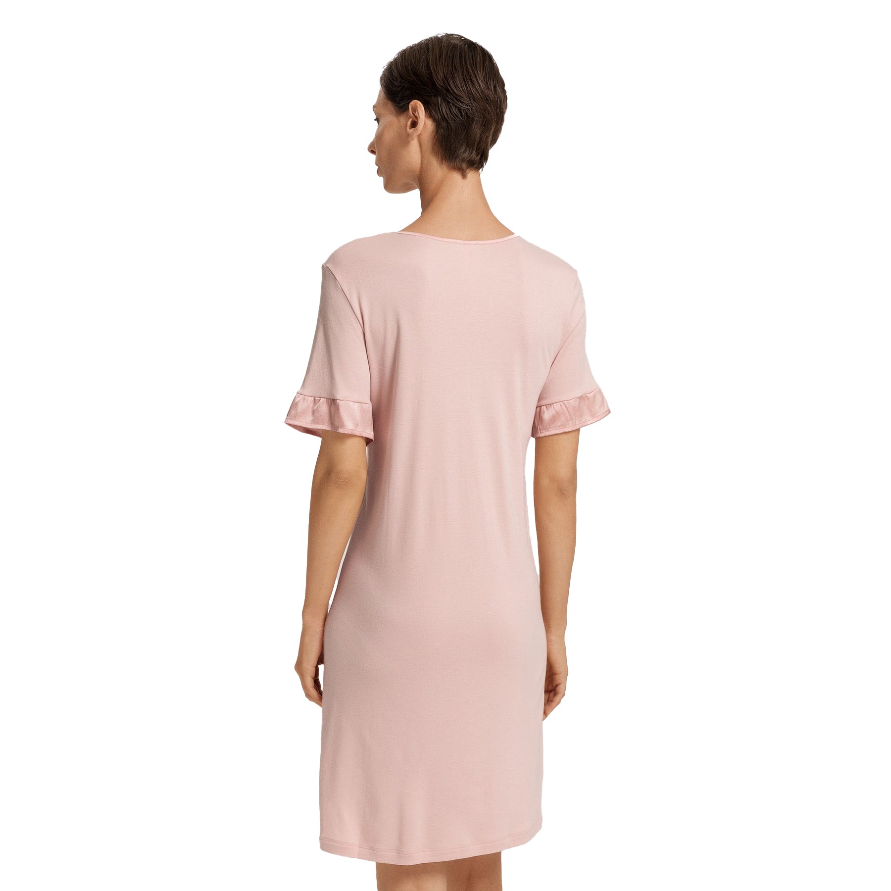 Back view of blush pink nightdress on model, featuring relaxed silhouette and knee-length cut.