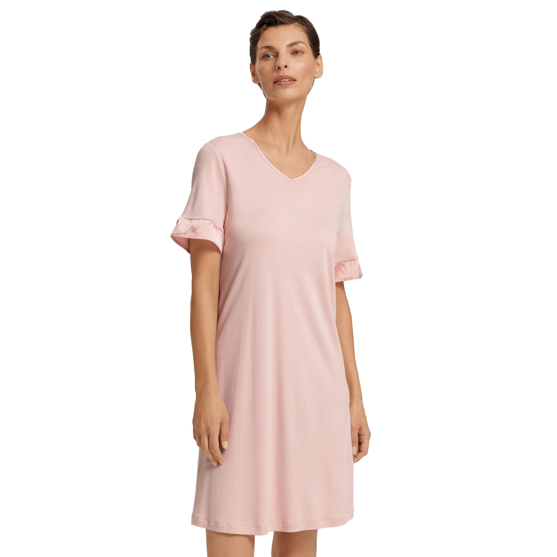 Model wearing blush pink short-sleeve nightdress with satin cuff detail, showing lightweight and elegant drape.