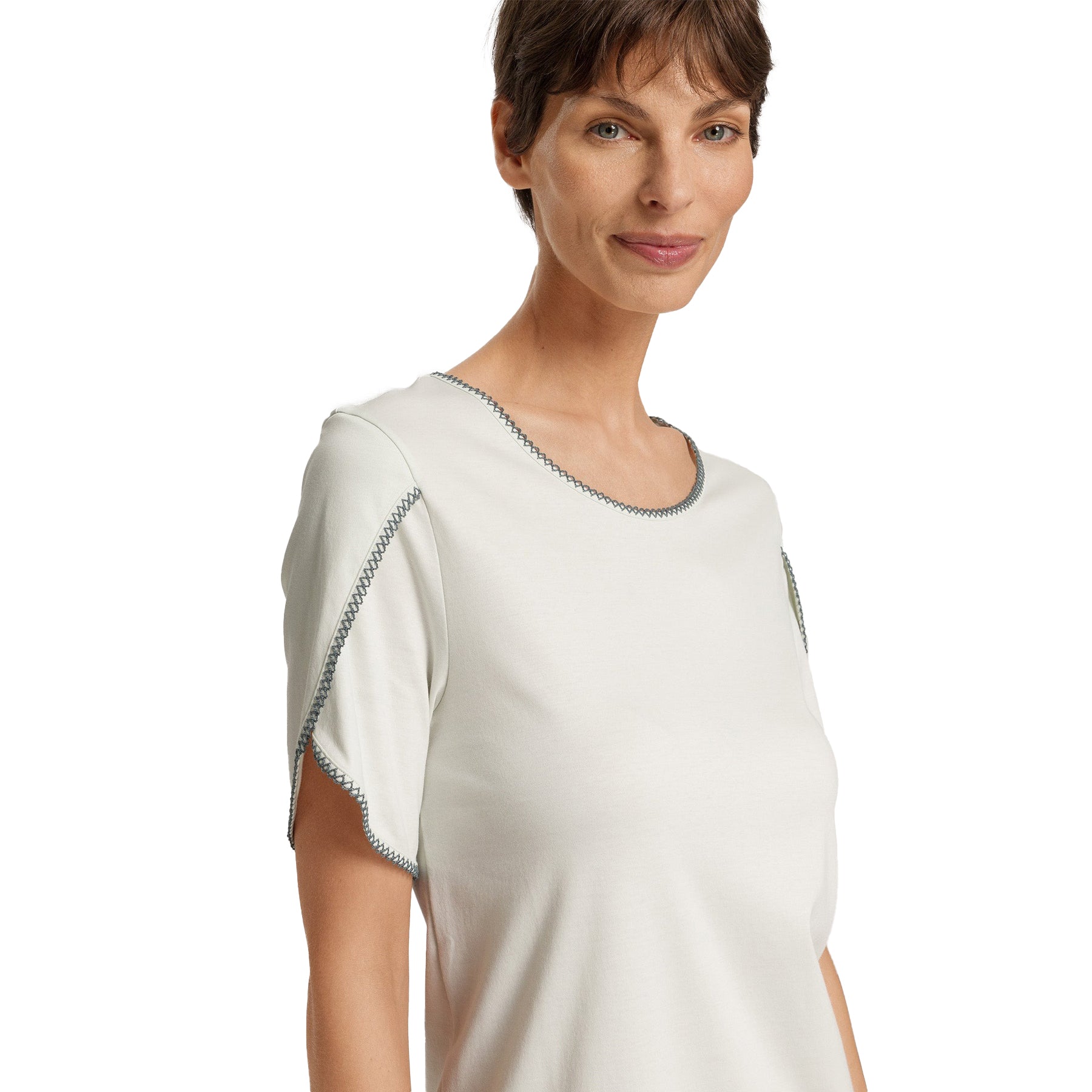 Close-up of neckline and sleeve detailing on light mint nightdress, showing dark contrast stitching.