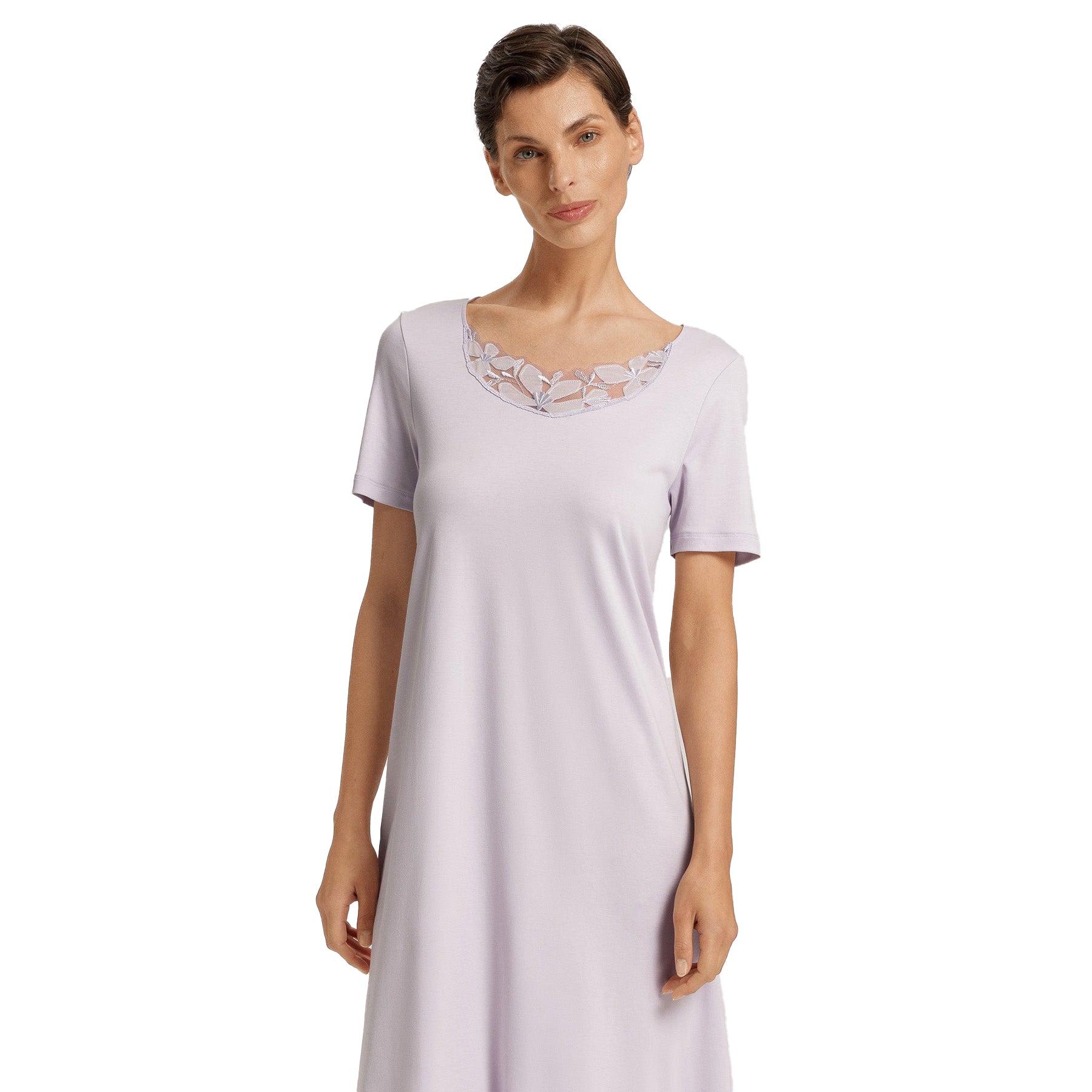 Woman modeling lavender Hanro nightgown highlighting embroidered lace neckline and soft drape.