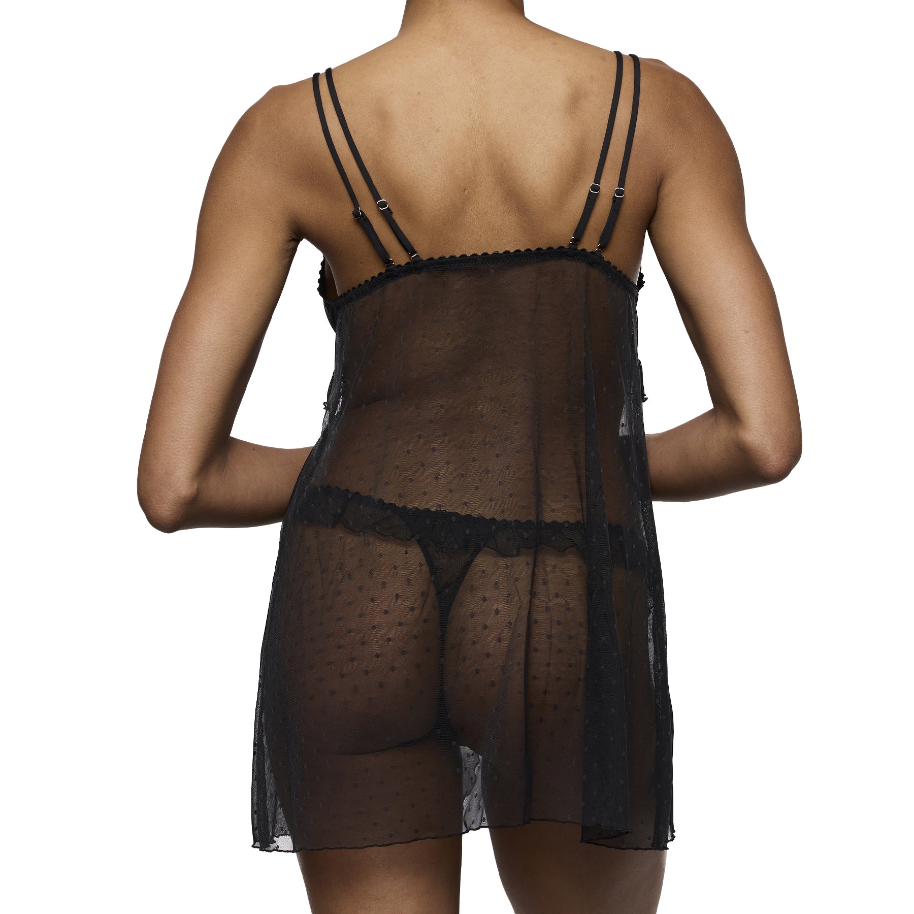 Back view of model wearing black Marie Jo Noova babydoll showing sheer dotted mesh back and adjustable straps.