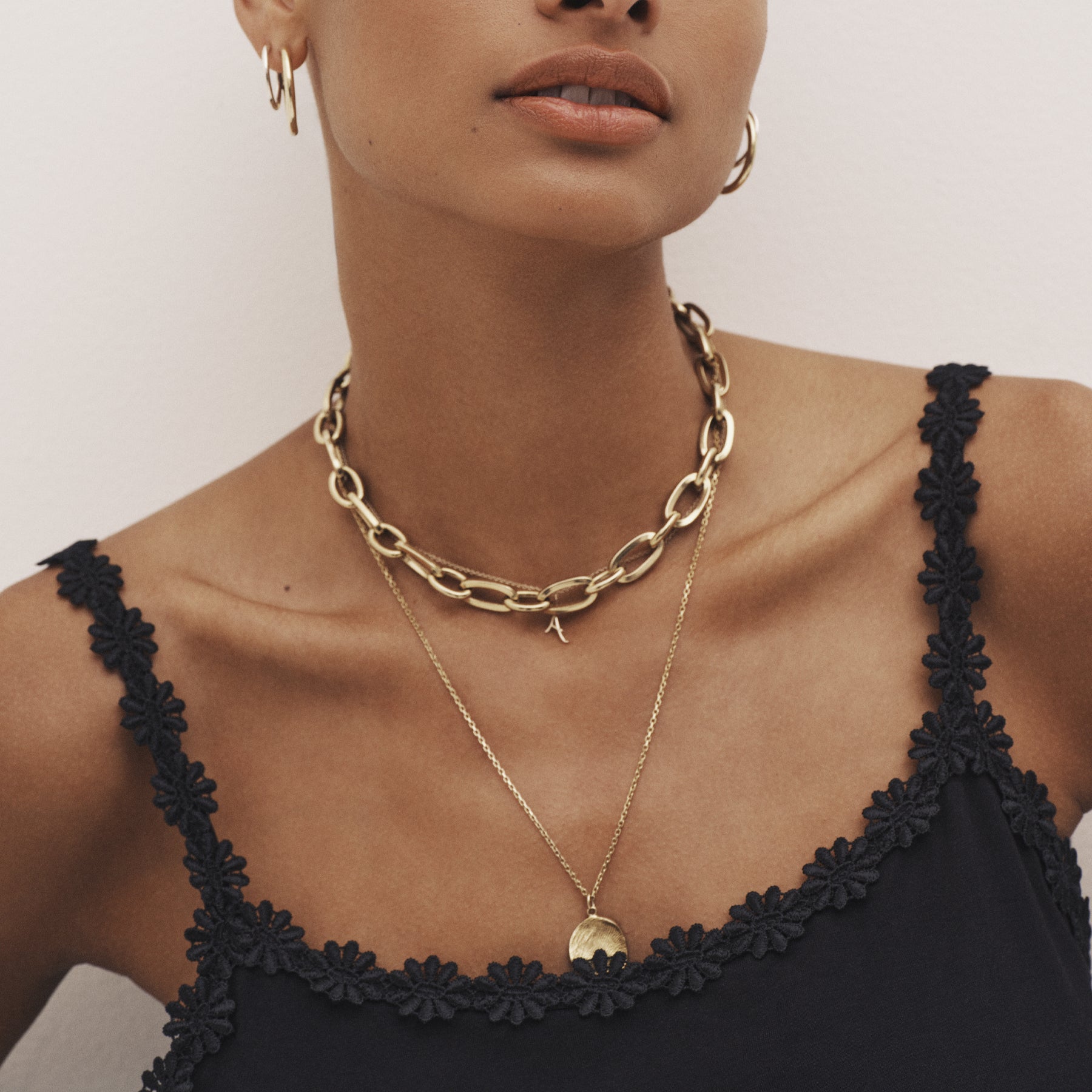 Close-up of black camisole neckline featuring delicate floral lace trim